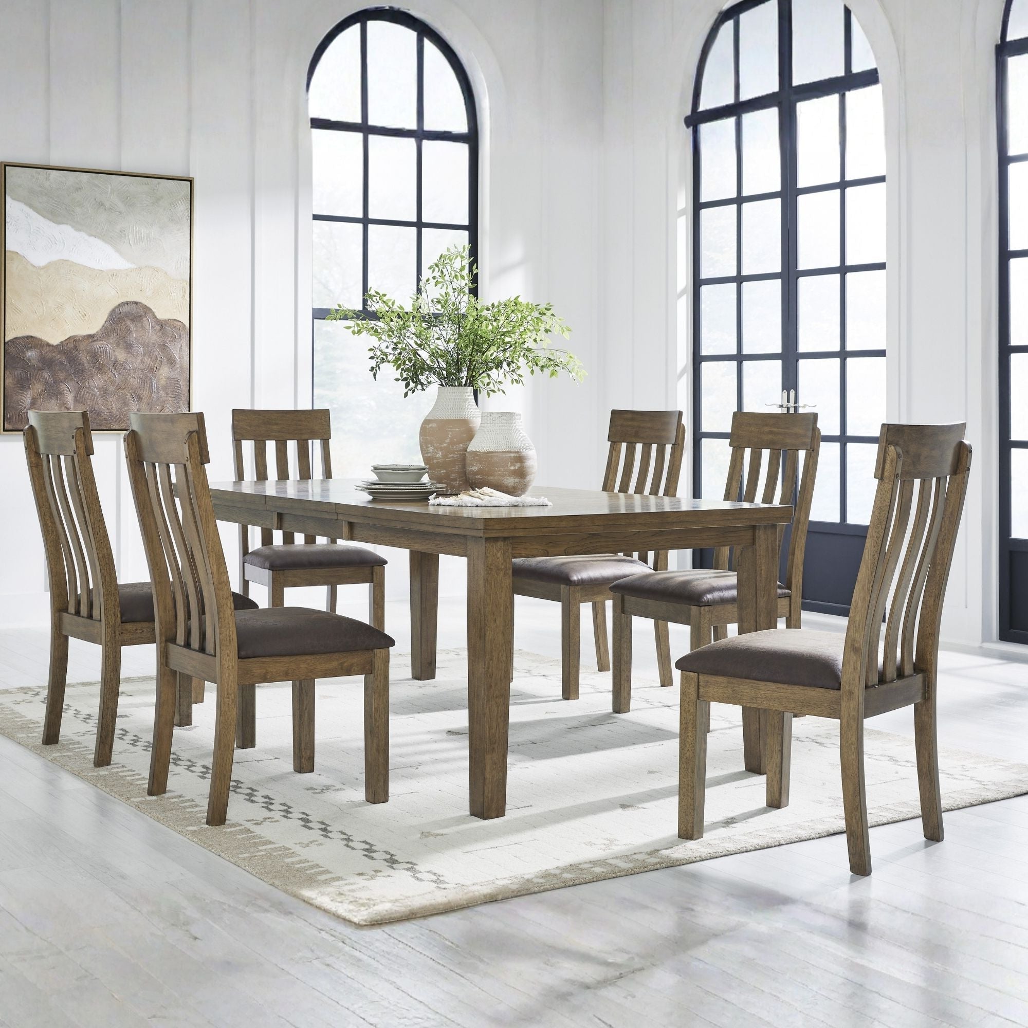 Light brown 7-piece Ashley dining room set with table and matching chairs, featuring a modern design and sturdy wood construction.