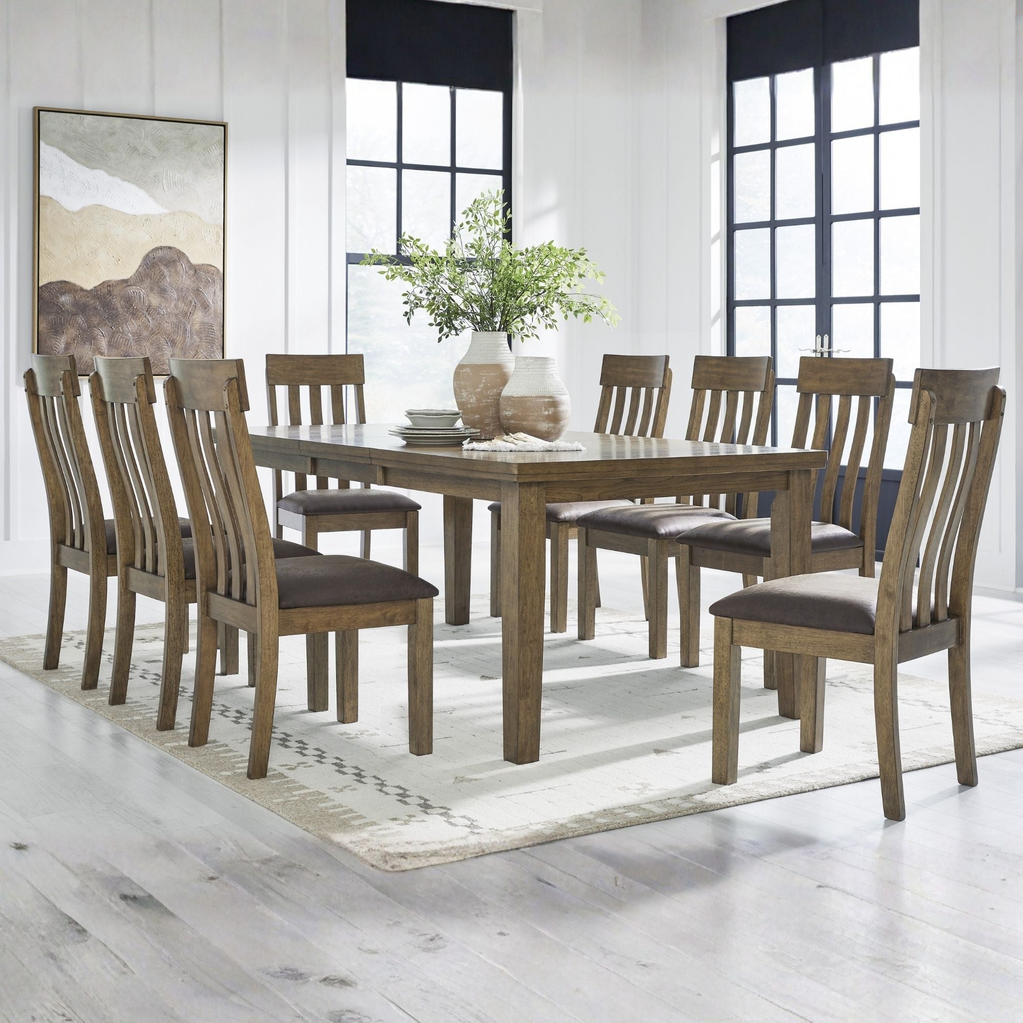 Light brown Ashley Urbinforte 9-piece dining room set with a table and matching chairs in a modern home dining space.