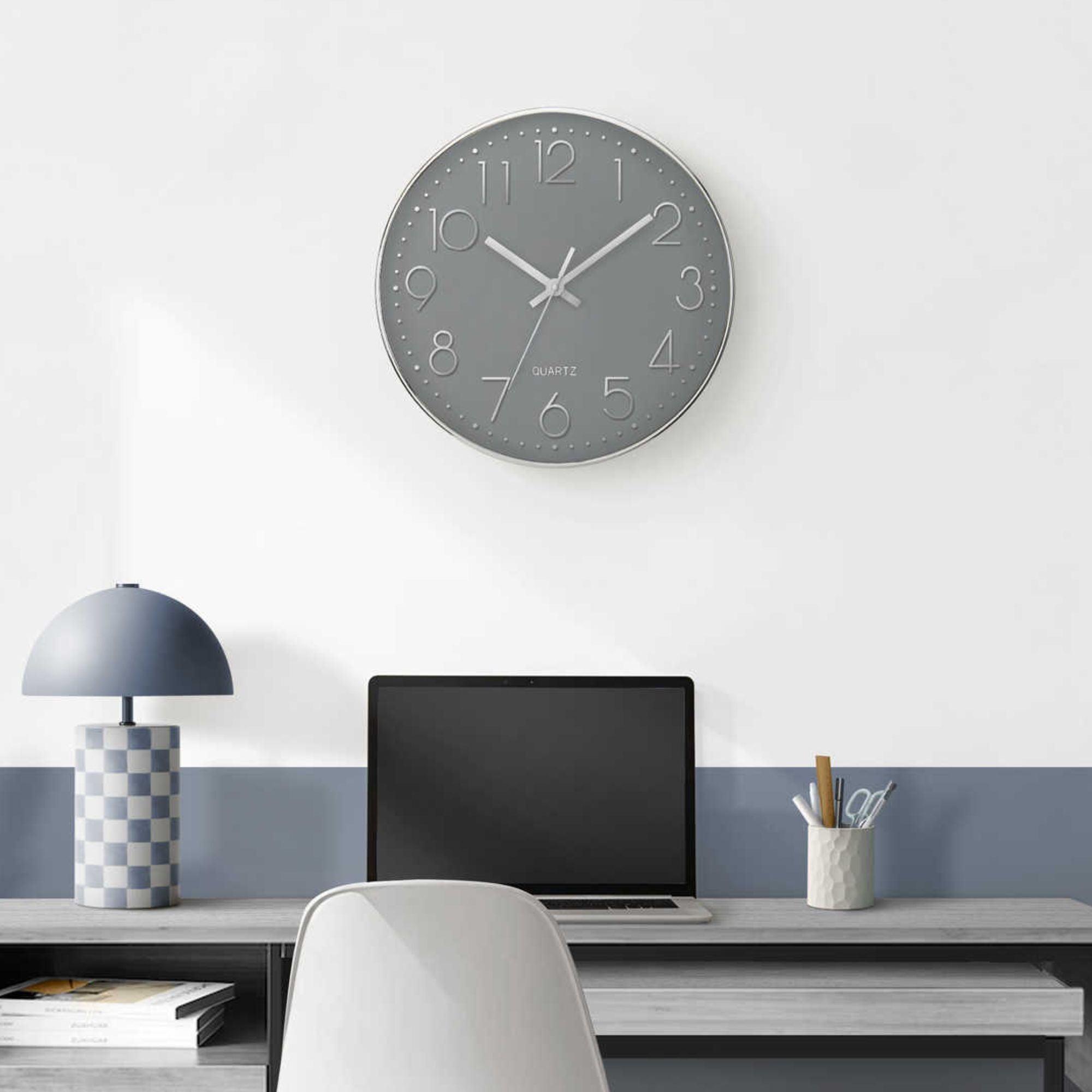 Modern grey wall clock with silver frame by Monarch Specialties, featuring a sleek 12-inch design and minimalist style.