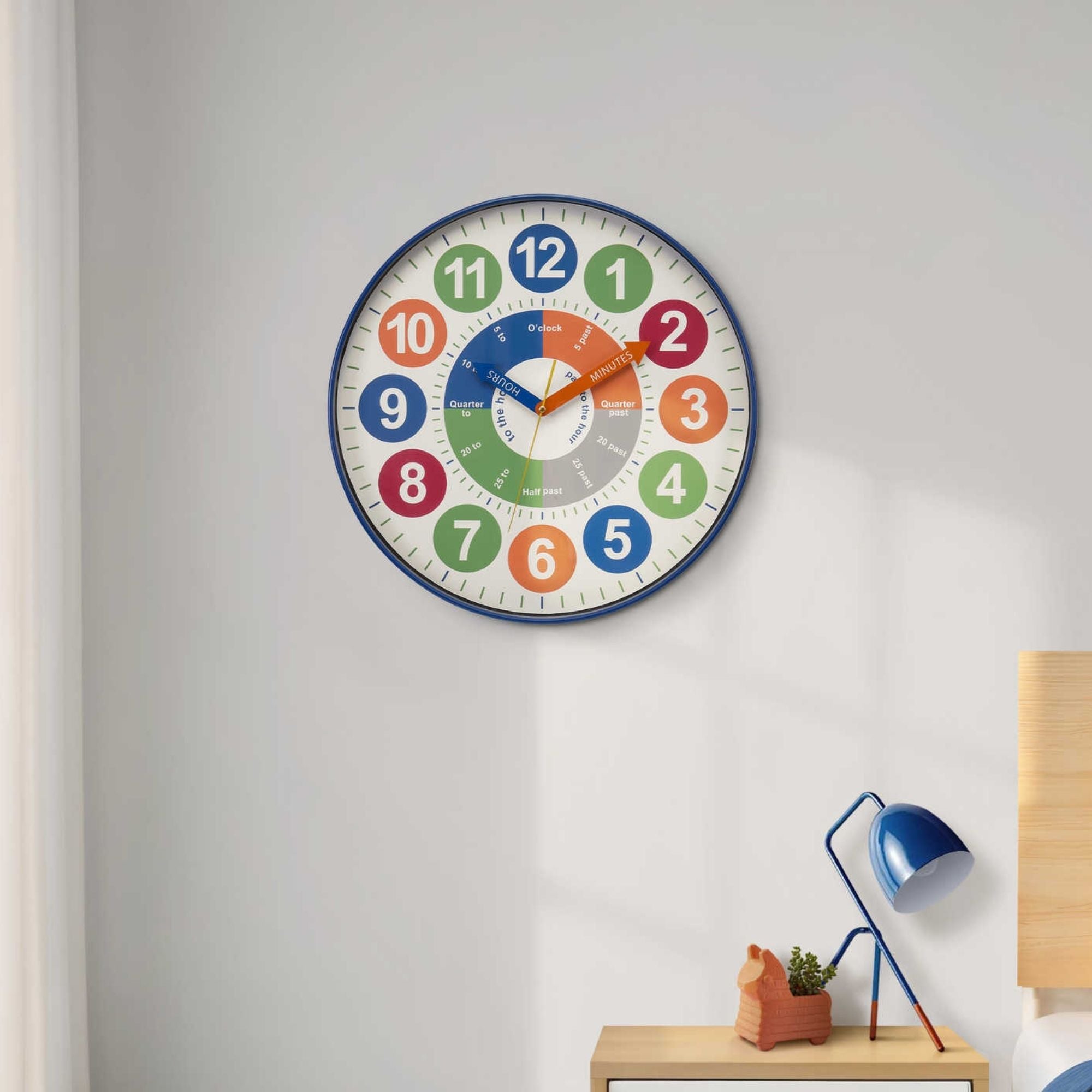 Multi-color 18-inch wall clock for kids by Monarch Specialties, featuring vibrant colors and playful design for children's rooms.