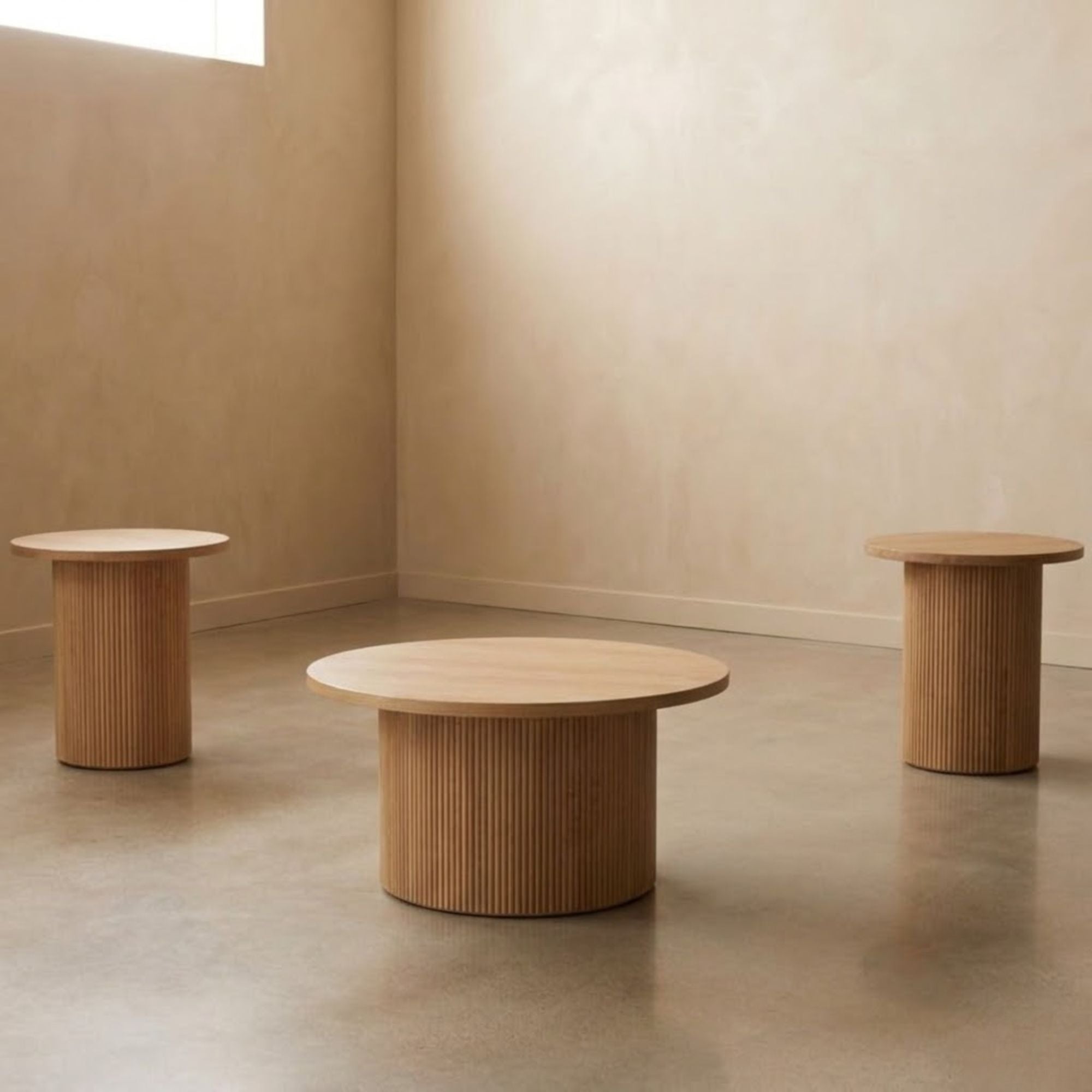 Set of three light natural wooden coffee tables from IFF Harper 3-Piece Table Set, arranged in a modern living room setting.