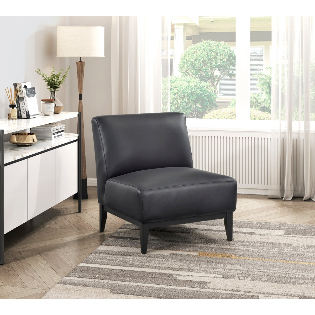 Black leather Houghton Slipper Chair by MAZ, an elegant accent chair with sleek design and comfortable seating.