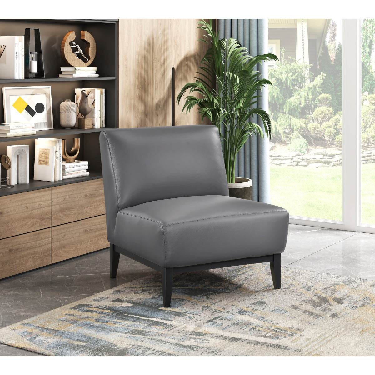Gray leather Houghton Slipper Accent Chair by MAZ, featuring smooth upholstery and a modern, comfortable design.