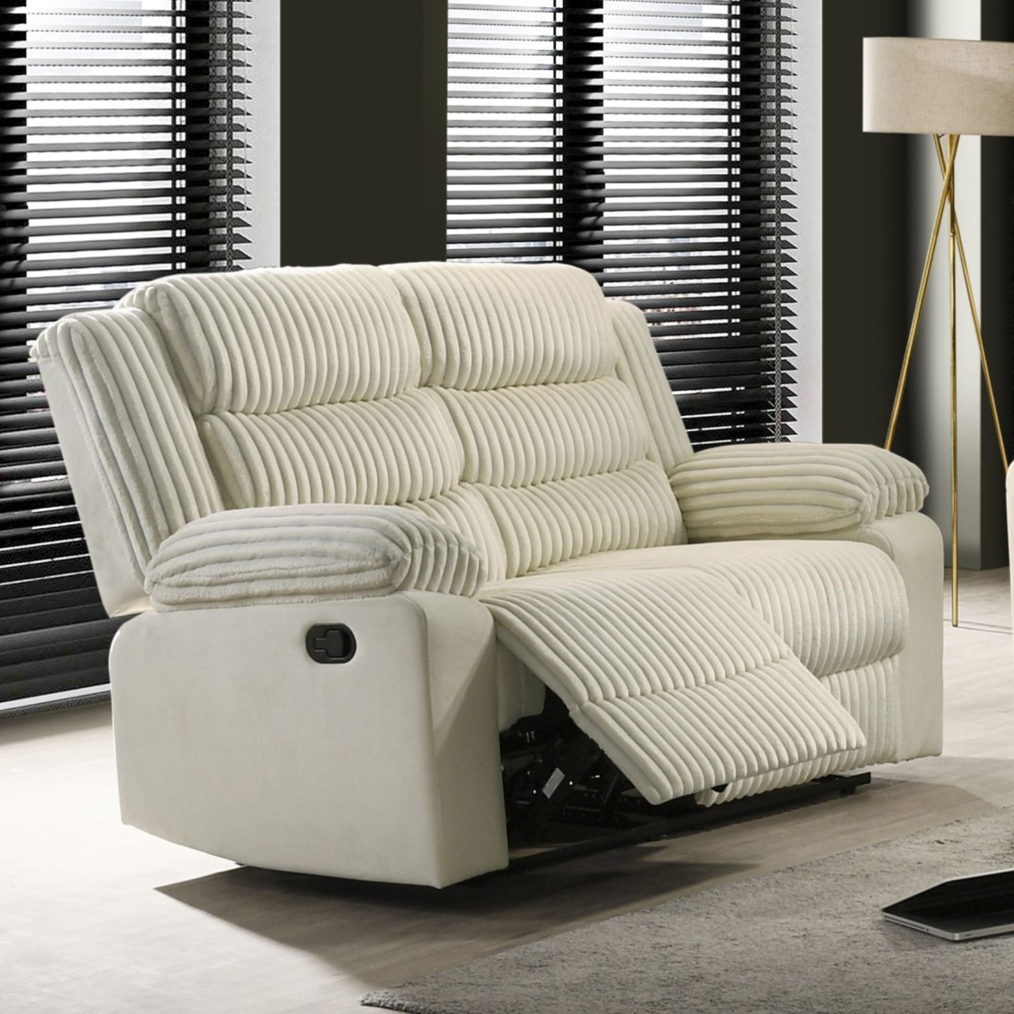 Cream recliner loveseat by Brassex featuring plush cushioning and reclining seats for comfortable lounging.