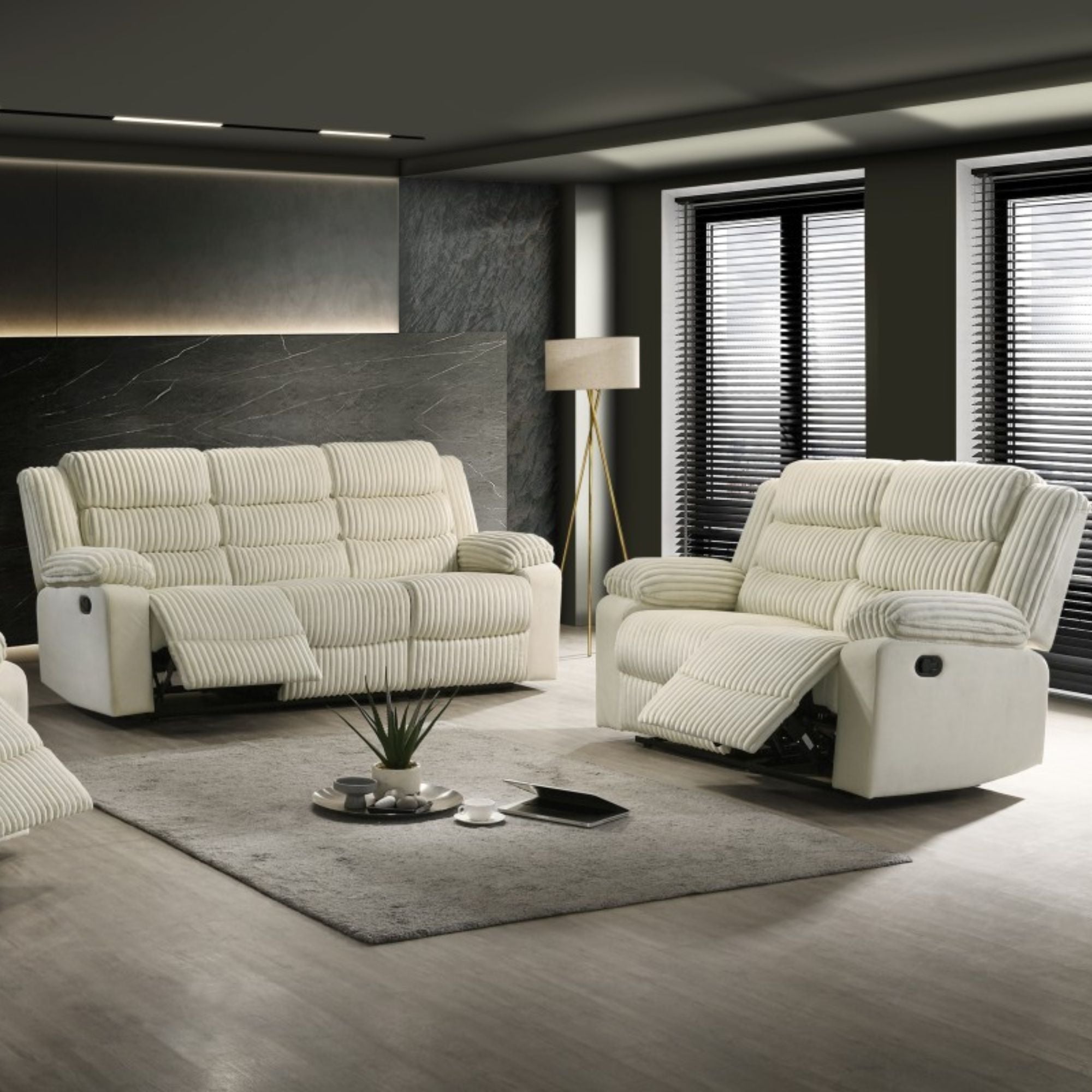 Cream recliner loveseat by Brassex with plush cushions and reclining feature, shown in a cozy living room setting.