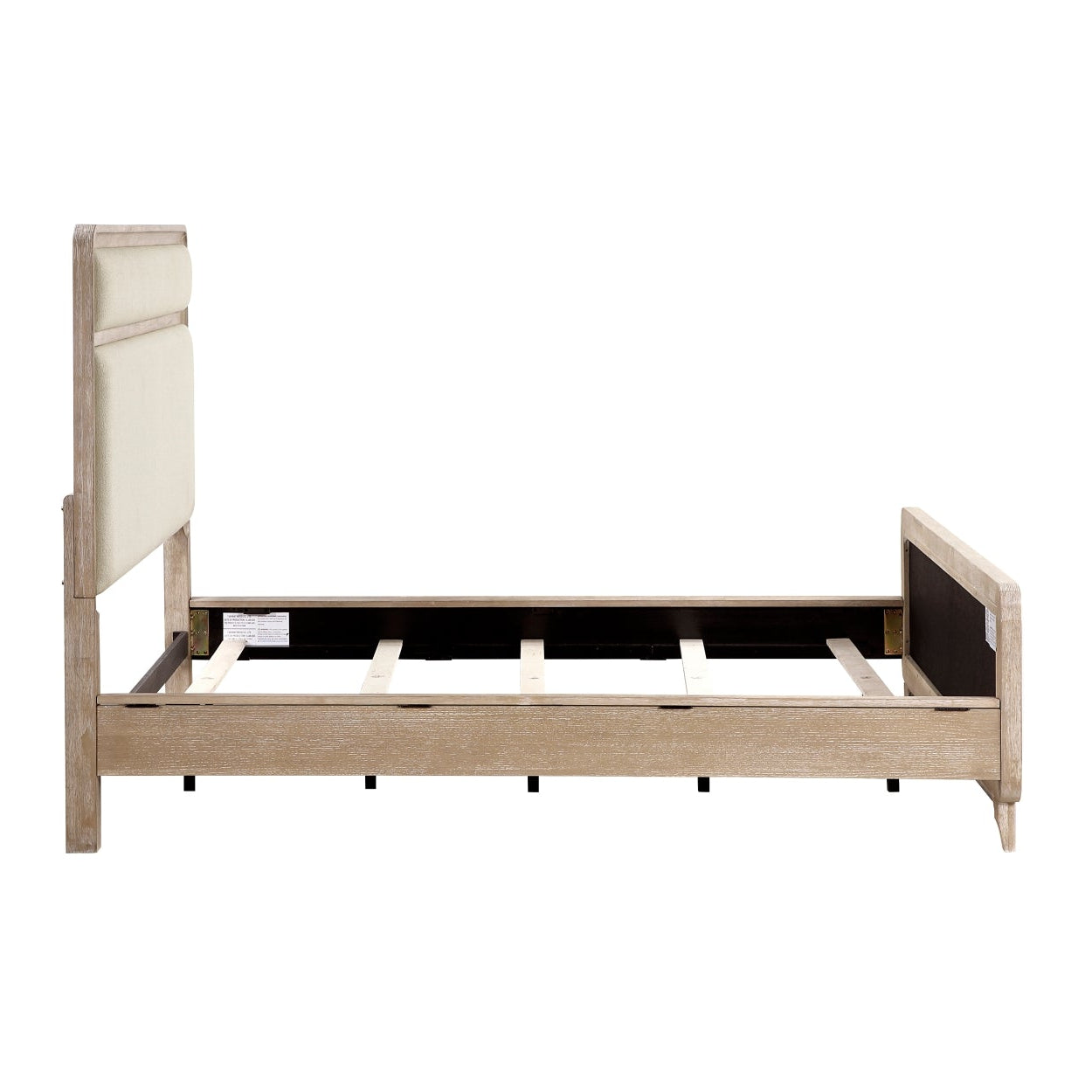 MAZ Wishire Collection beige bed with side view, modern design and upholstered headboard, in a well-lit bedroom setting.