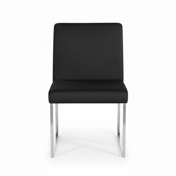 Set of two black Brassex dining chairs with sleek, modern design and cushioned seats for comfortable dining room seating.
