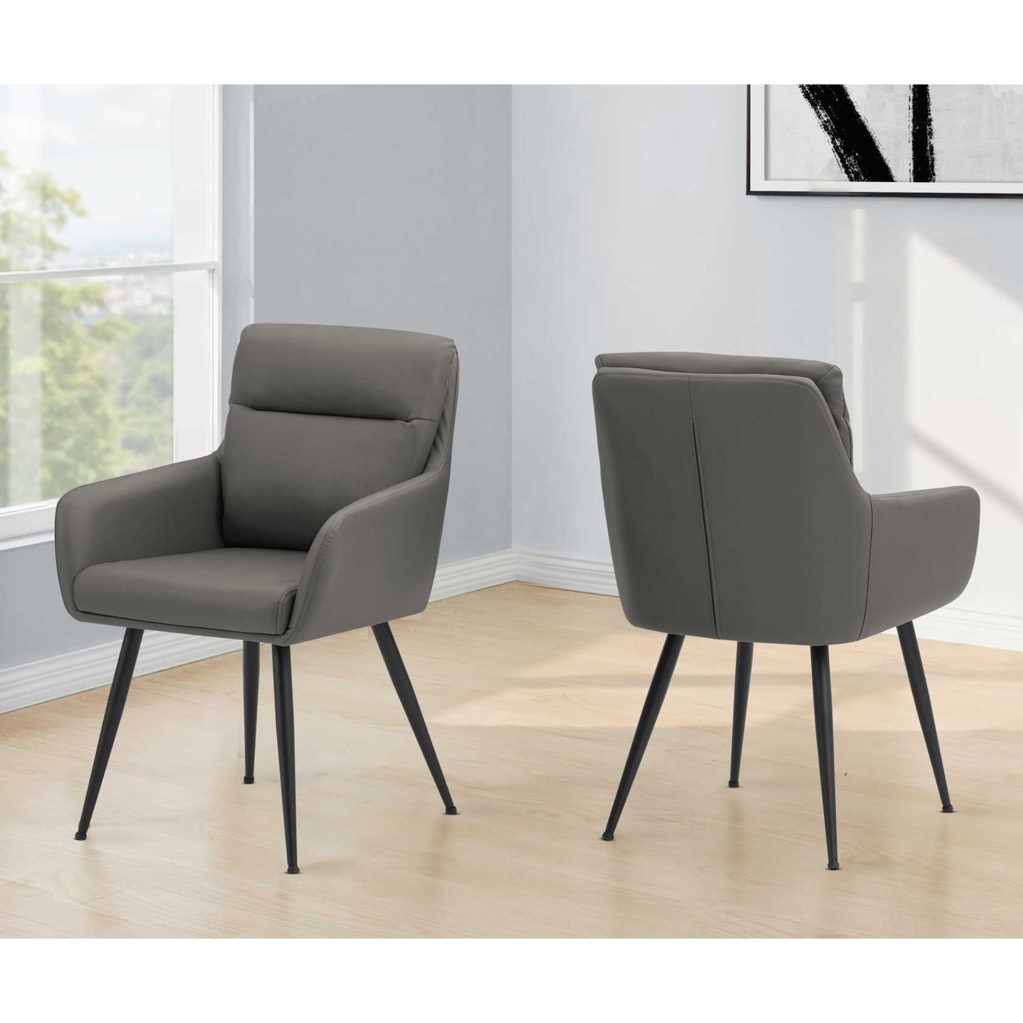 Pair of grey leather-look Monarch Specialties dining chairs with sleek, modern design and sturdy wooden legs.