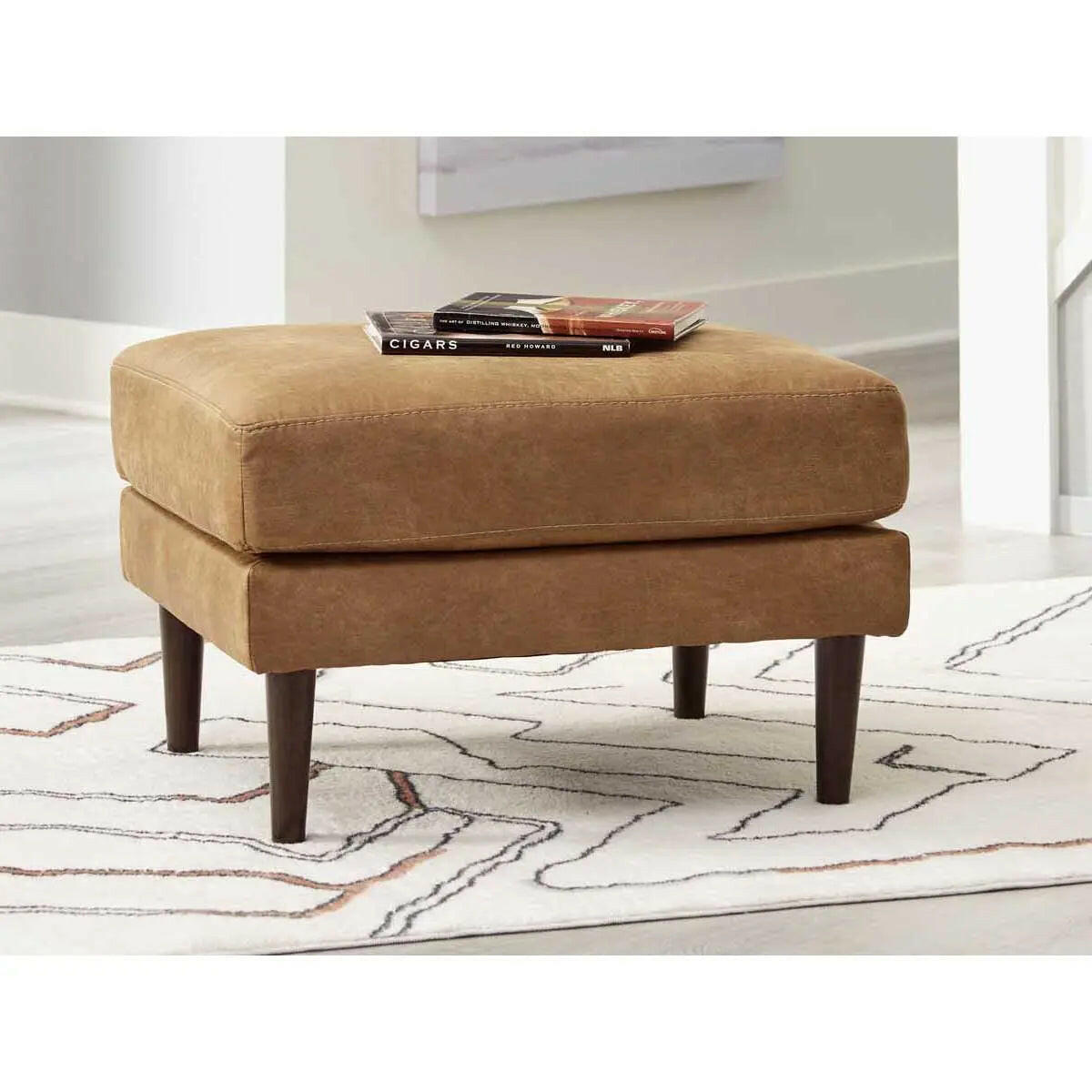 Ashley Telora caramel ottoman from Signature Design by Ashley, showing a plush, upholstered bench with a smooth, caramel-colored fabric.