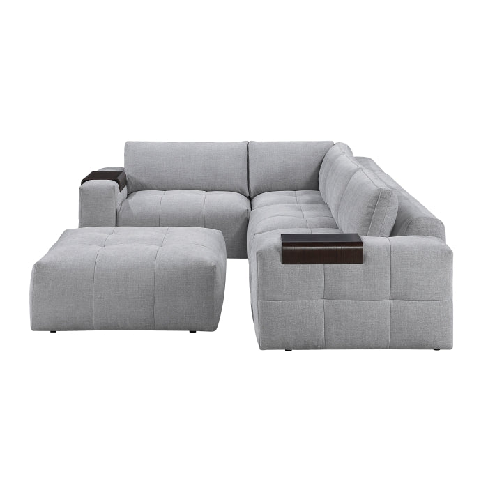 MAZ Tidal 5-piece modular sectional sofa with matching ottoman in grey fabric, shown from side view.