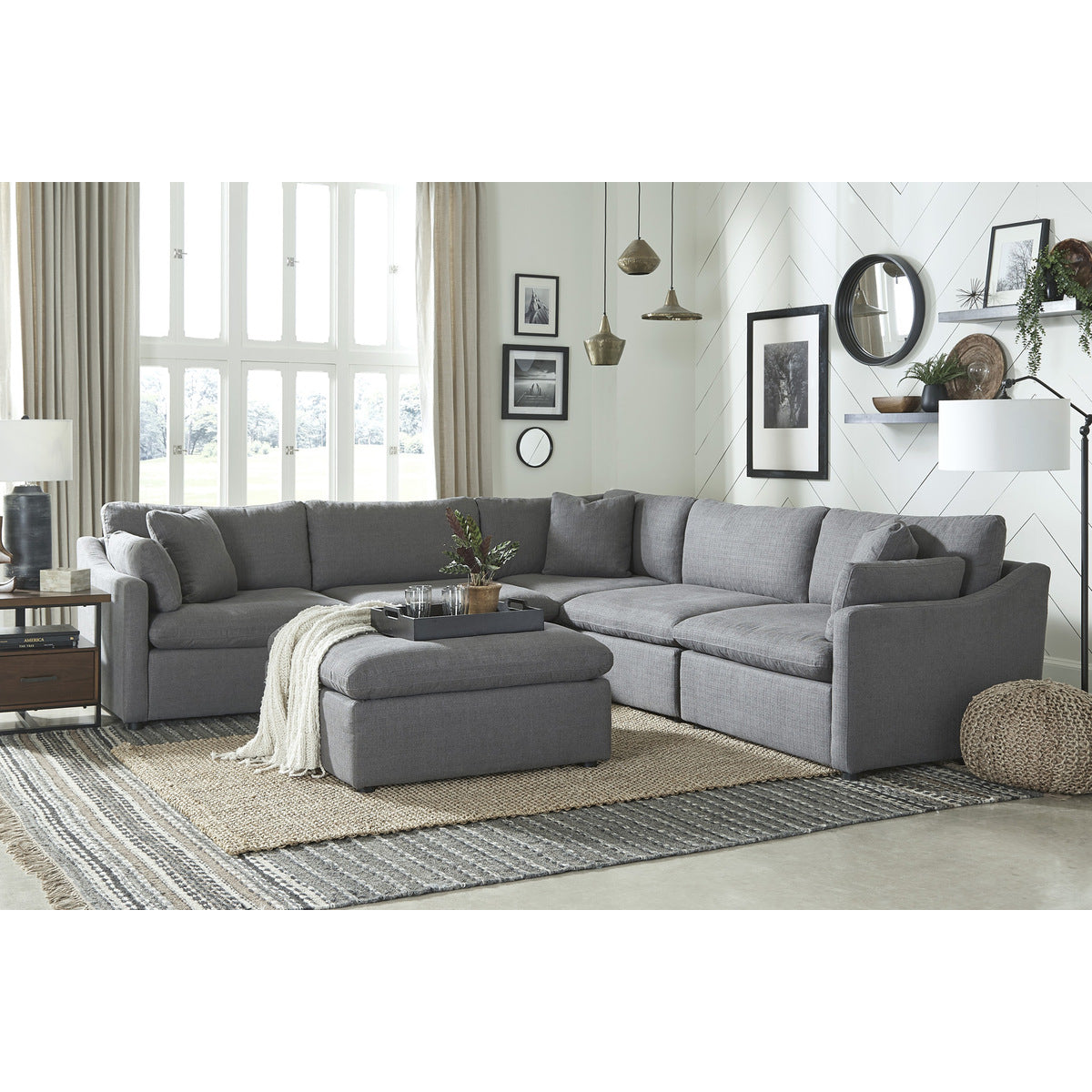Gray Howerton Collection 6-piece modular sectional sofa with ottoman by MAZ, showing plush cushions and modern design.