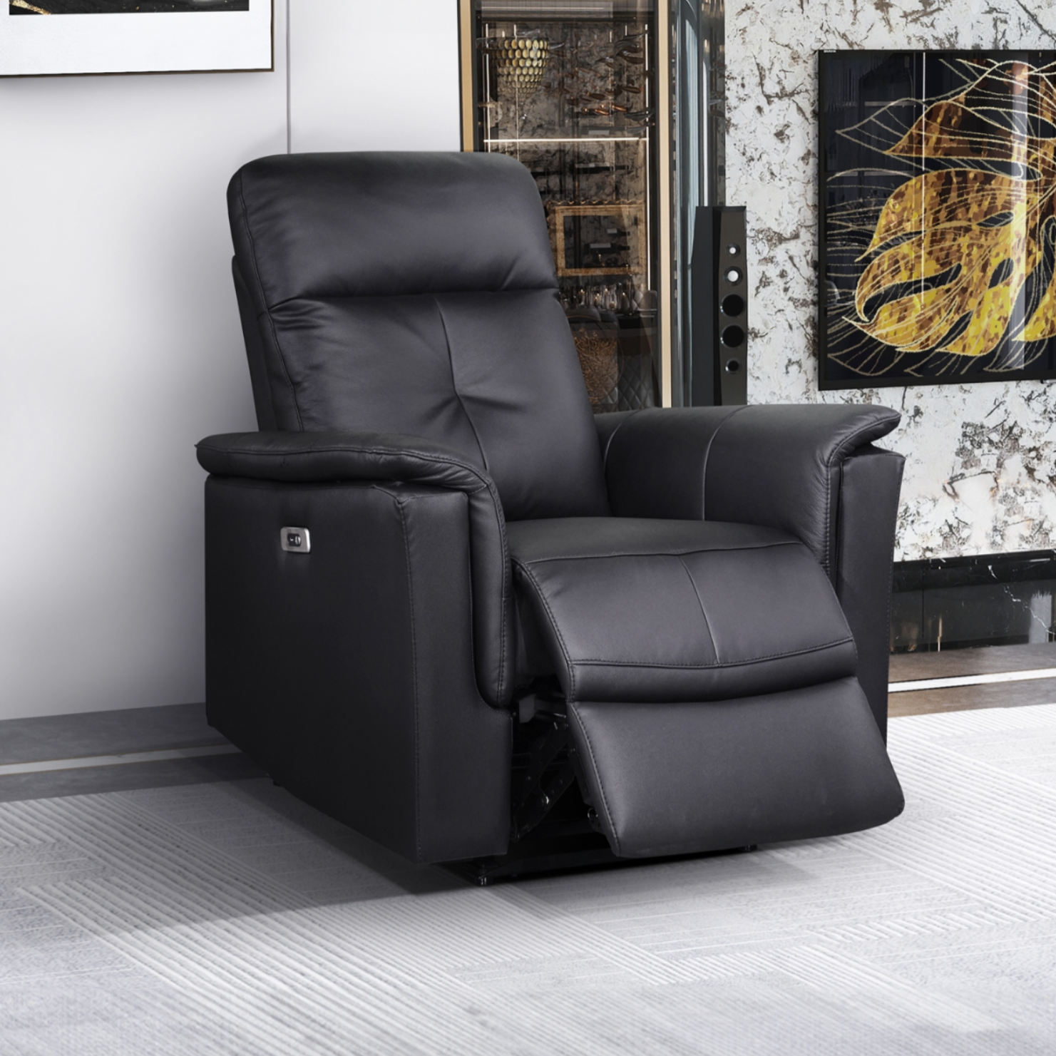 Black MAZ Bristow Power Glider Recliner chair with padded armrests and plush cushioning, shown from a side angle.