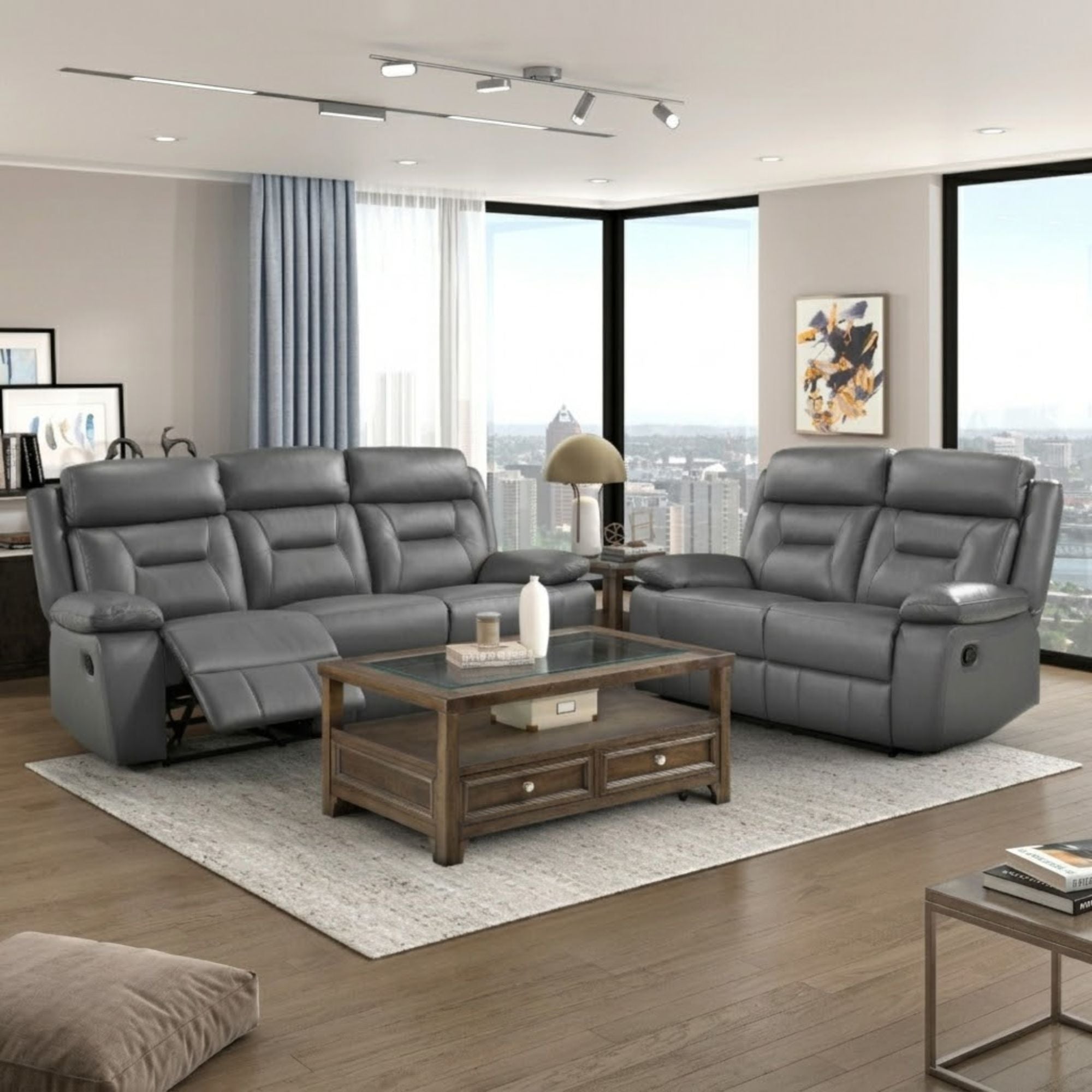 Gray leather reclining sofa from the MAZ Laconia Collection, featuring plush cushions and a sleek, modern design.