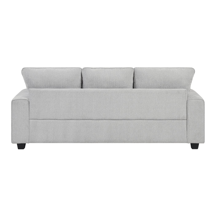 MAZ Sarah 3-seat sofa shown from the back, featuring plush upholstery and wooden legs in a modern living room setting.
