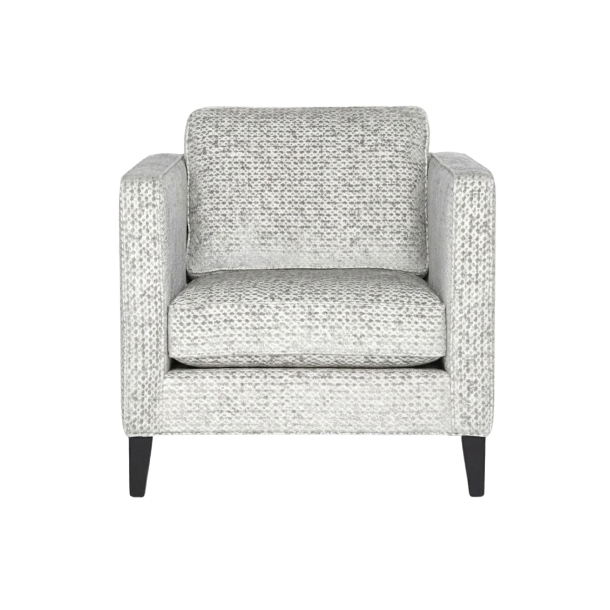Gray Adam Collection accent chair by Statum Designs Inc with wooden legs and plush upholstery, shown from a side angle.