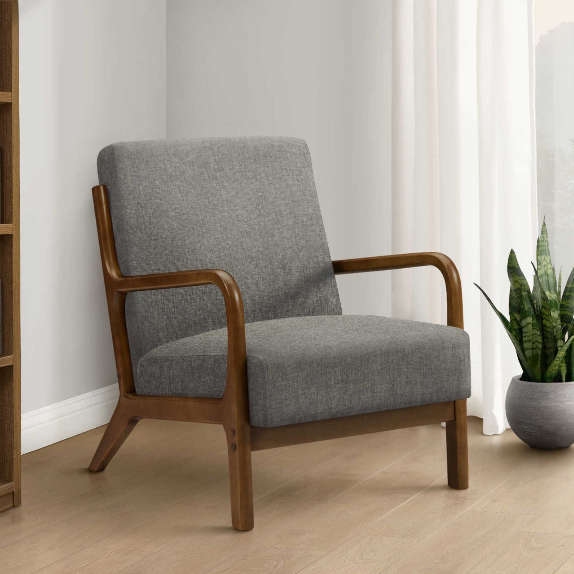 Grey fabric accent chair with walnut wood legs, modern style, featuring cushioned seat and back for comfortable seating.
