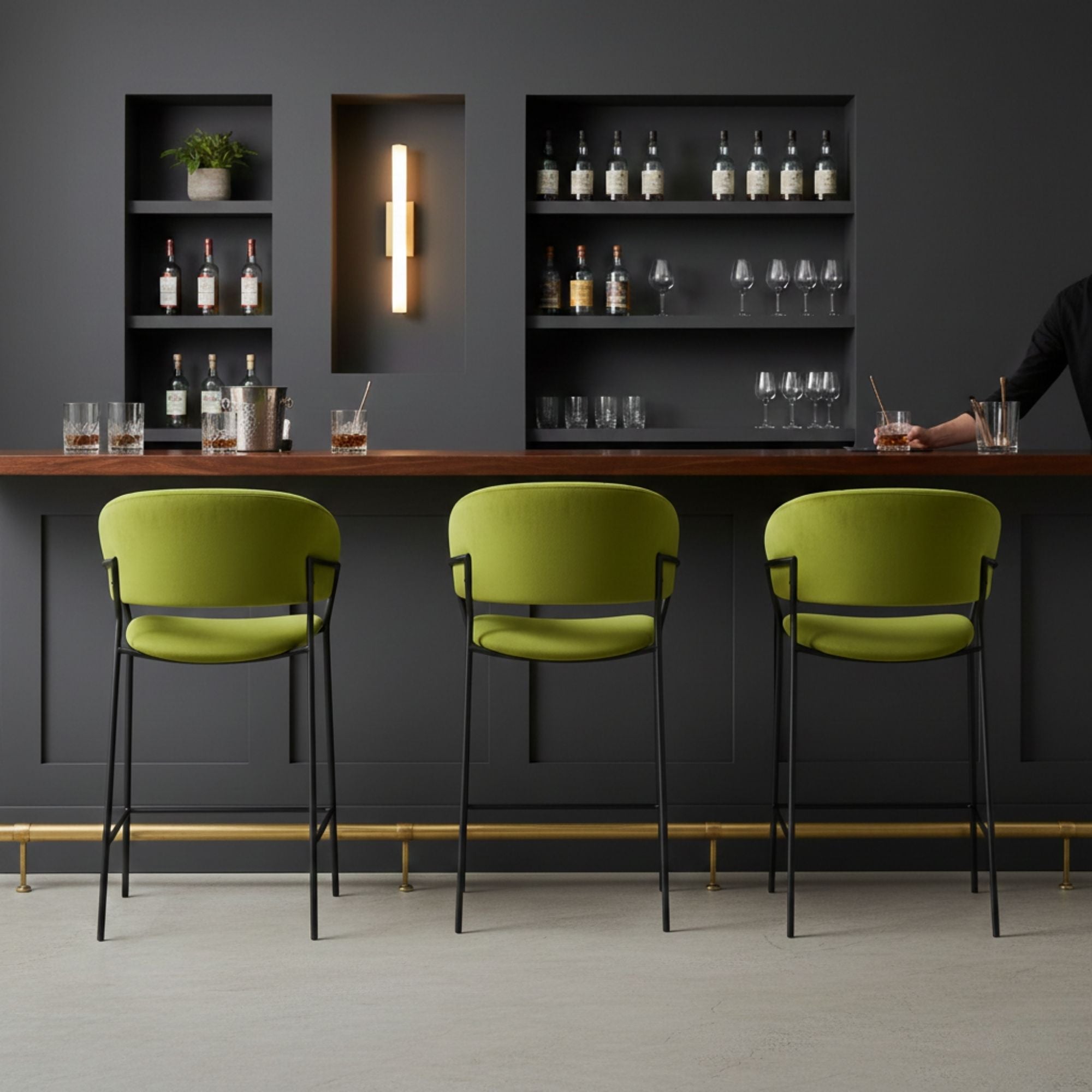 Green Amanda counter bar stool by Elite Living with a sleek, modern design and wooden legs, shown in a set.