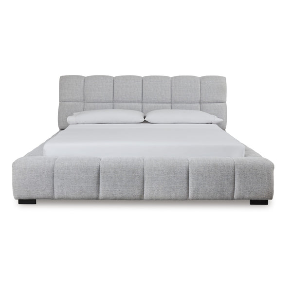 Light gray upholstered Ashley bed from the Grendusk collection, showcasing a stylish and comfortable bedroom furniture piece.