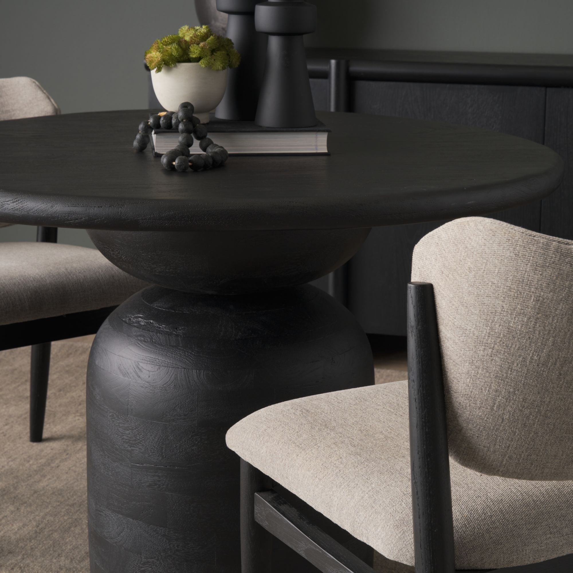 Black wood round dining table from Mercana Atlas Collection with a sleek 42-inch design, perfect for modern dining spaces.