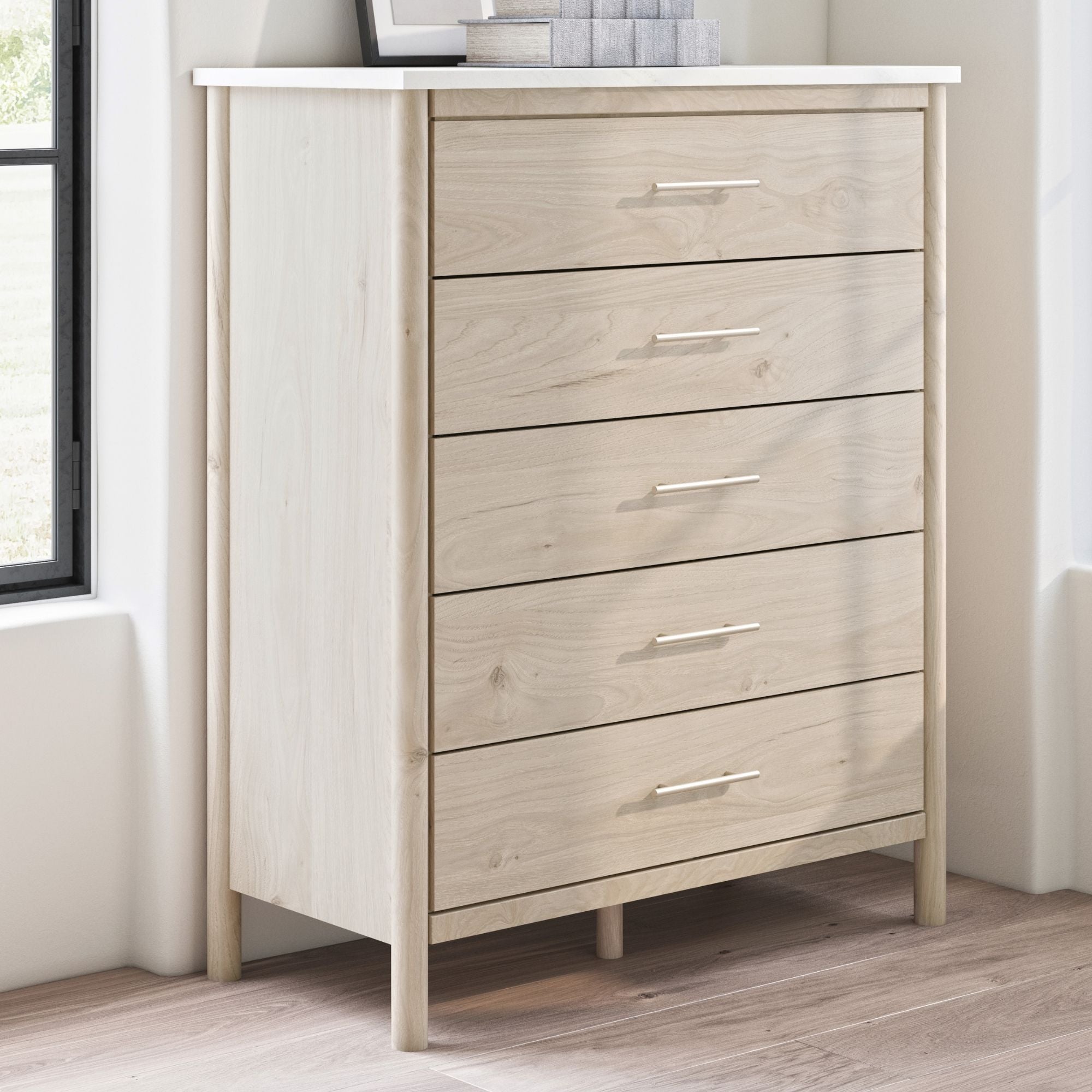 Natural wood Cadmori five-drawer wide chest by Signature Ashley, showing its spacious drawers and elegant bedroom storage design.