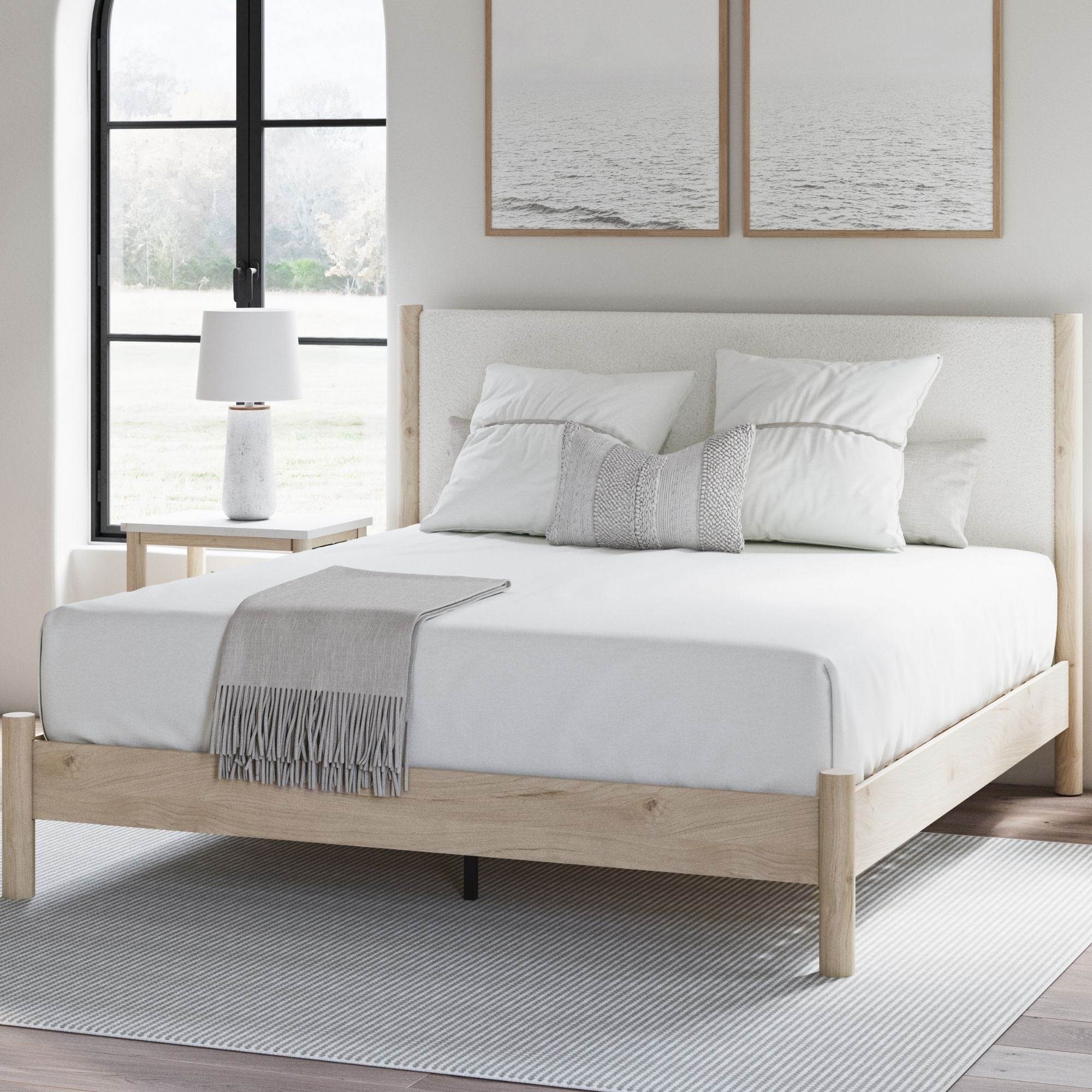 Signature Ashley Cadmori upholstered panel platform bed in natural finish, showcasing a modern bedroom setup with clean lines and plush headboard.