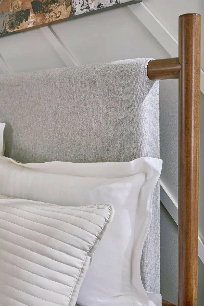 Close-up of Signature Design by Ashley Lyncott upholstered panel bedroom set showing fabric texture and detailed headboard design.