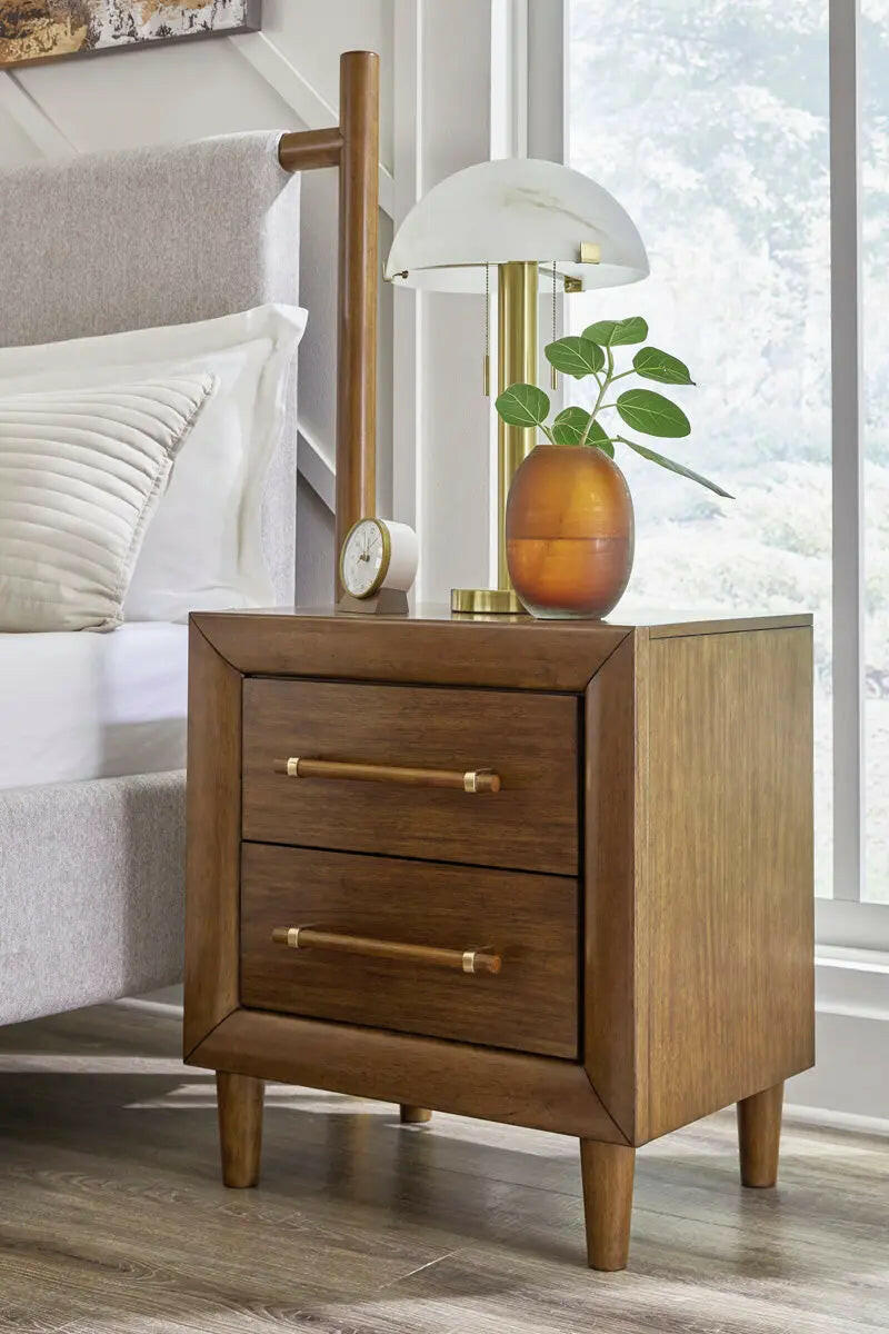 Signature Design by Ashley Lyncott upholstered panel bedroom set featuring a bed with a padded headboard and matching nightstands.