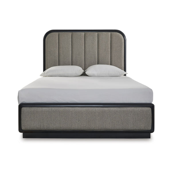 Signature Design by Ashley Rowanbeck Collection upholstered panel bed with a plush headboard in a stylish bedroom setting.