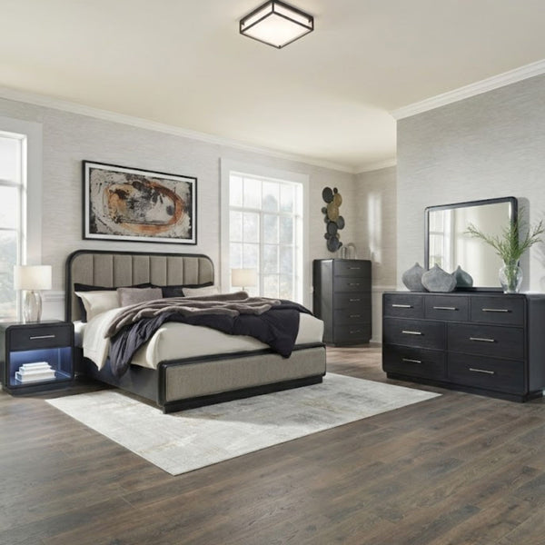 Signature Design by Ashley Rowanbeck upholstered panel bedroom set with a bed, dresser, and nightstands in a modern bedroom setup.