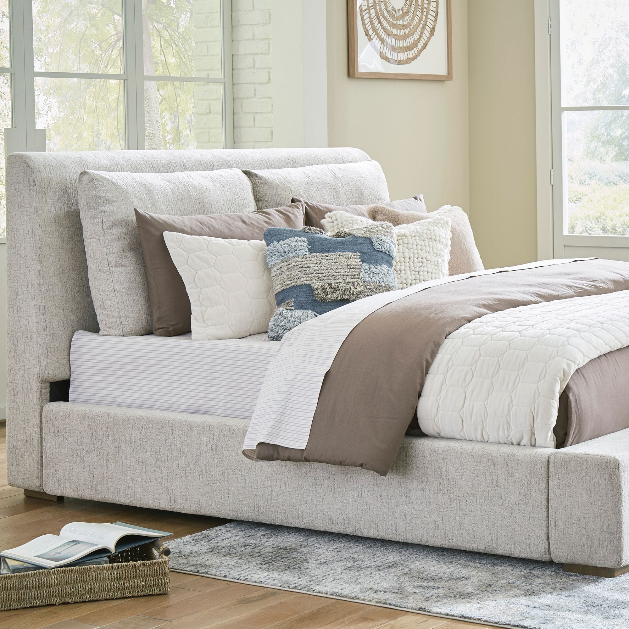 Signature Ashley Cabalynn upholstered bed with tufted headboard and fabric upholstery, shown in a modern bedroom setting.