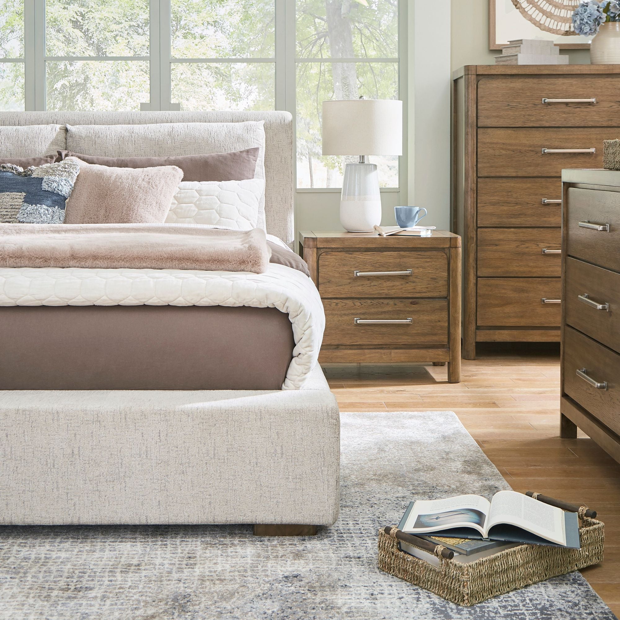 Signature Ashley Cabalynn upholstered bed with a padded headboard and neutral fabric, shown in a modern bedroom setting.