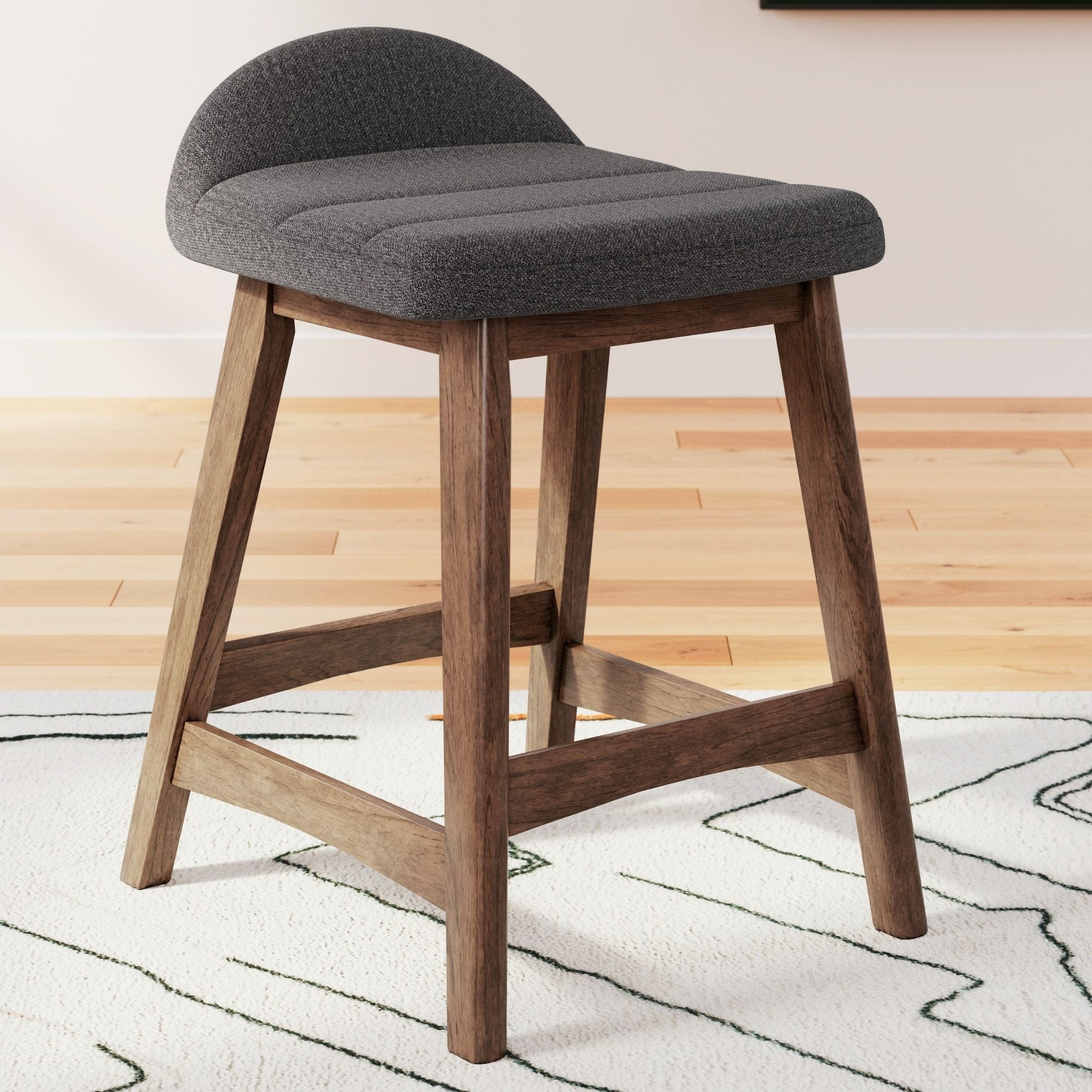 Set of two charcoal upholstered Ashley Signature bar stools with sleek design and sturdy wooden legs.
