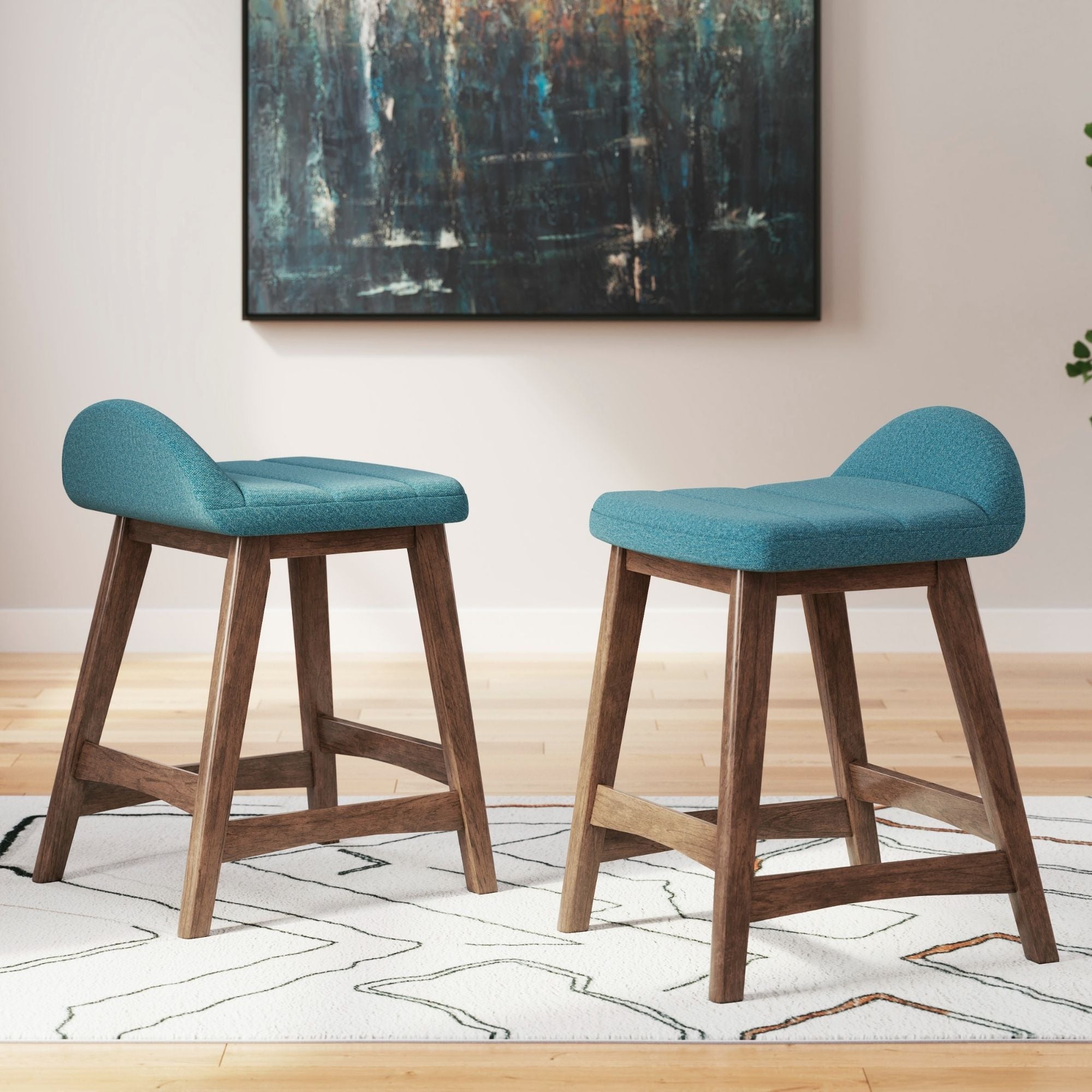 Set of two blue upholstered Signature Ashley barstools with padded seats and backrests, perfect for kitchen or home bar areas.