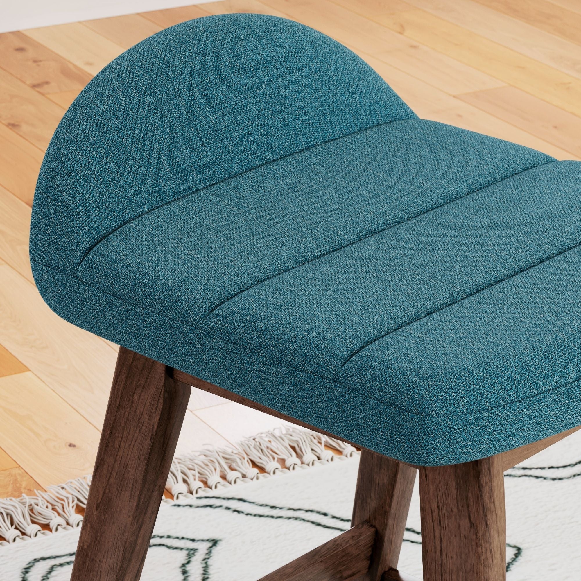 Two blue upholstered Ashley Signature bar stools with wooden legs and backrests, ideal for modern kitchen or bar area.