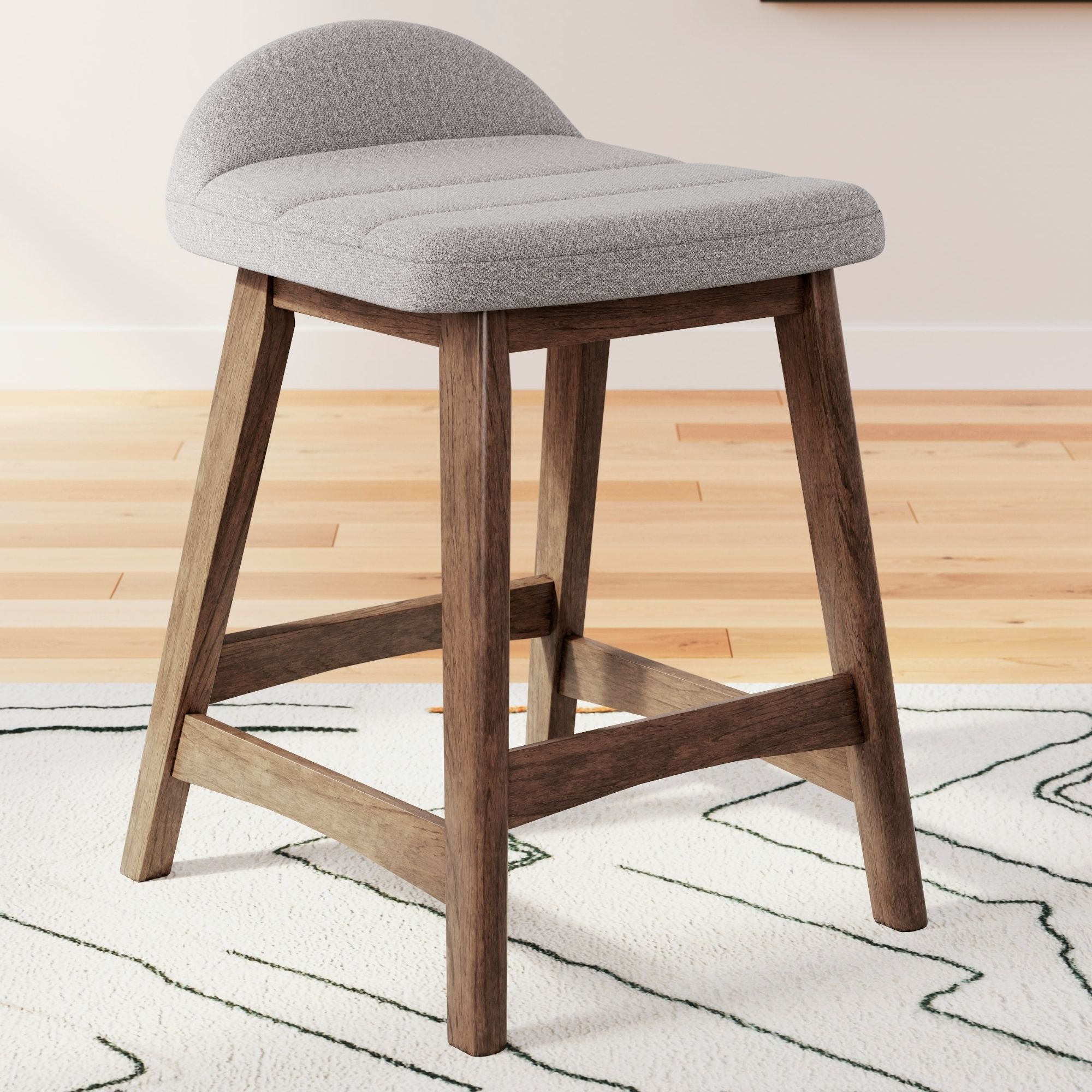 Set of two Lyncott upholstered barstools in light grey fabric with wooden legs, designed for modern kitchen or bar area.