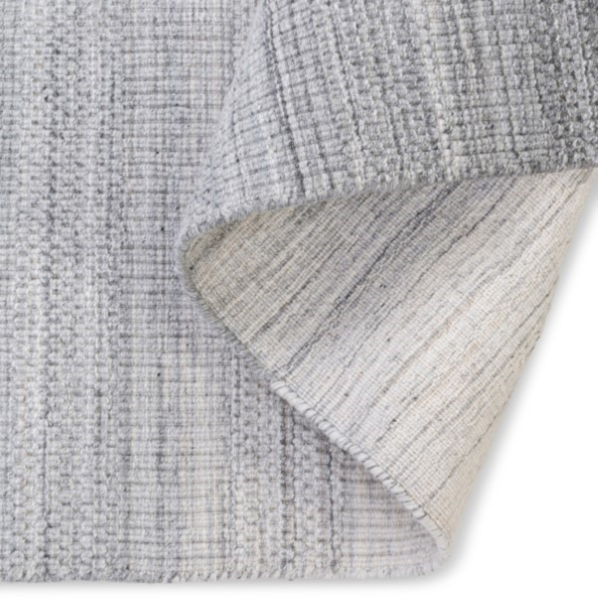 Viana Inc Celeste handloom area rug with intricate woven patterns in neutral tones, showcasing artisanal craftsmanship.