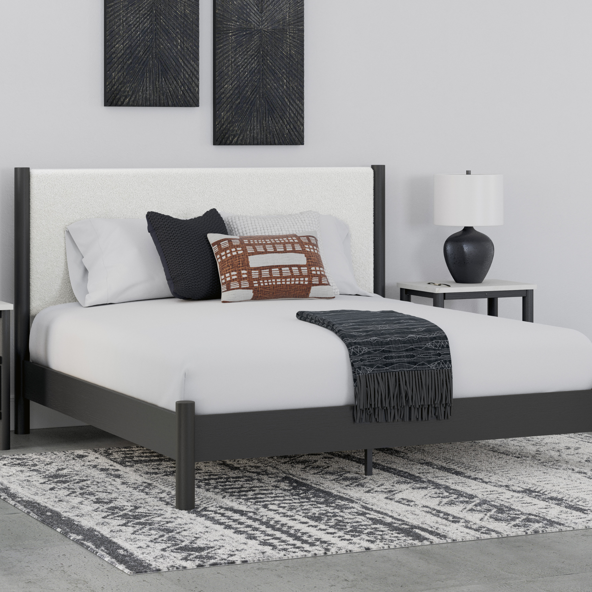 Black Cadmori upholstered panel platform bed by Signature Ashley, shown in a modern bedroom setting with clean lines and soft lighting.