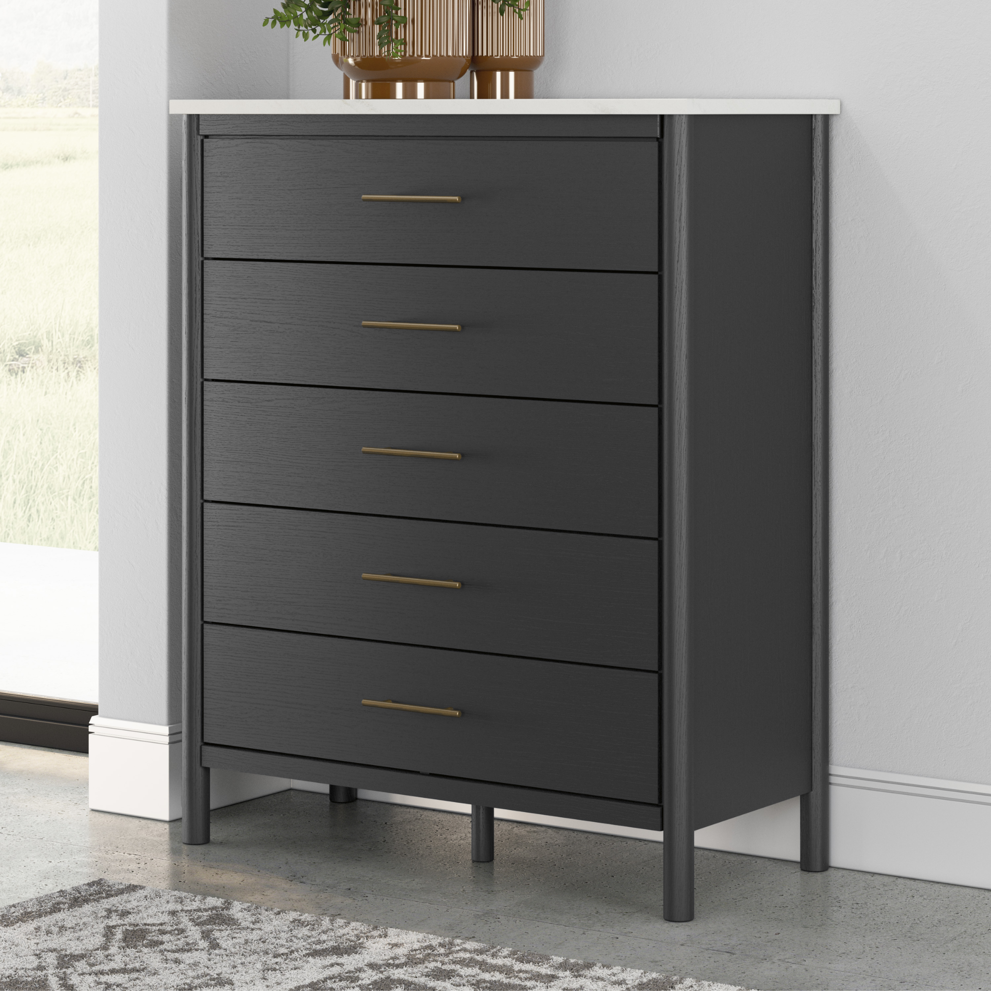 Black Cadmori five-drawer wide chest by Signature Ashley, showcasing sleek design and spacious storage in a modern bedroom setting.