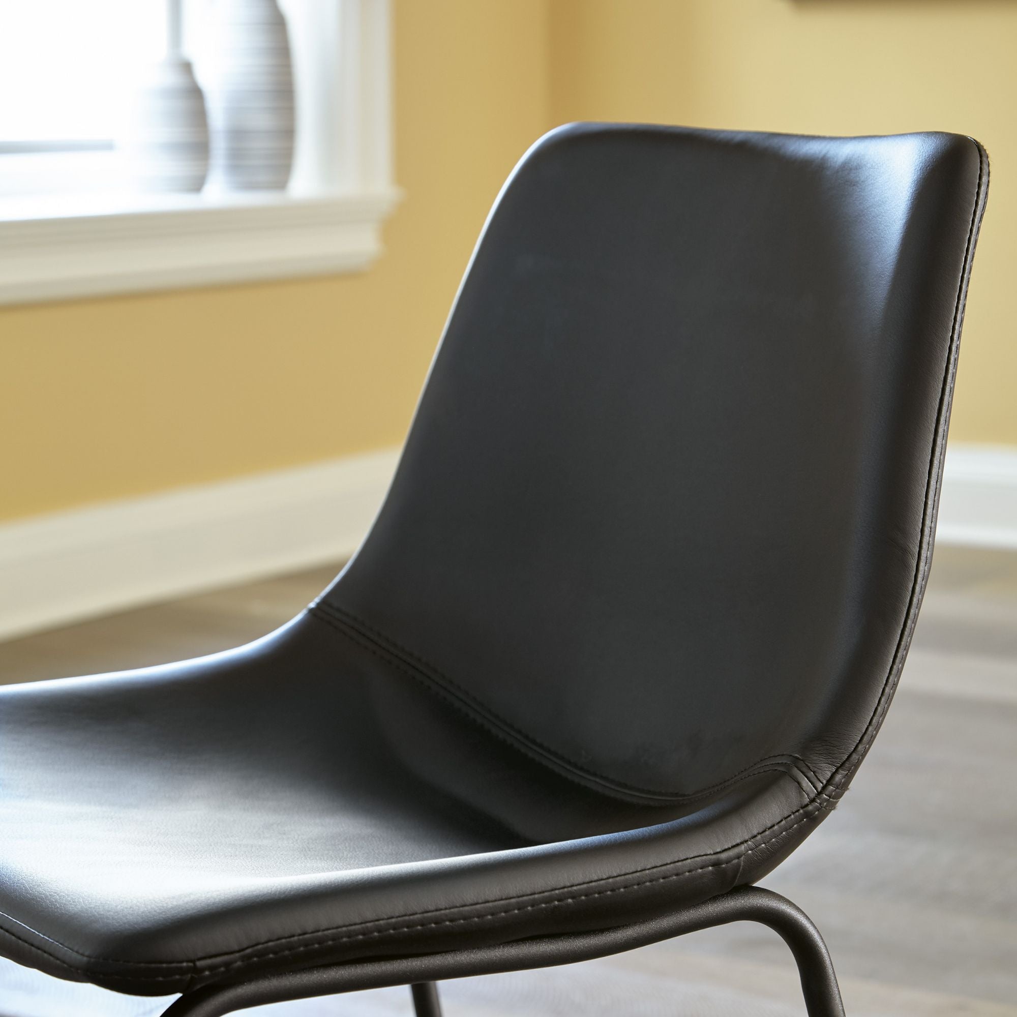 Set of two black Centiar UPH dining chairs by Signature Ashley, featuring modern design and upholstered seats.