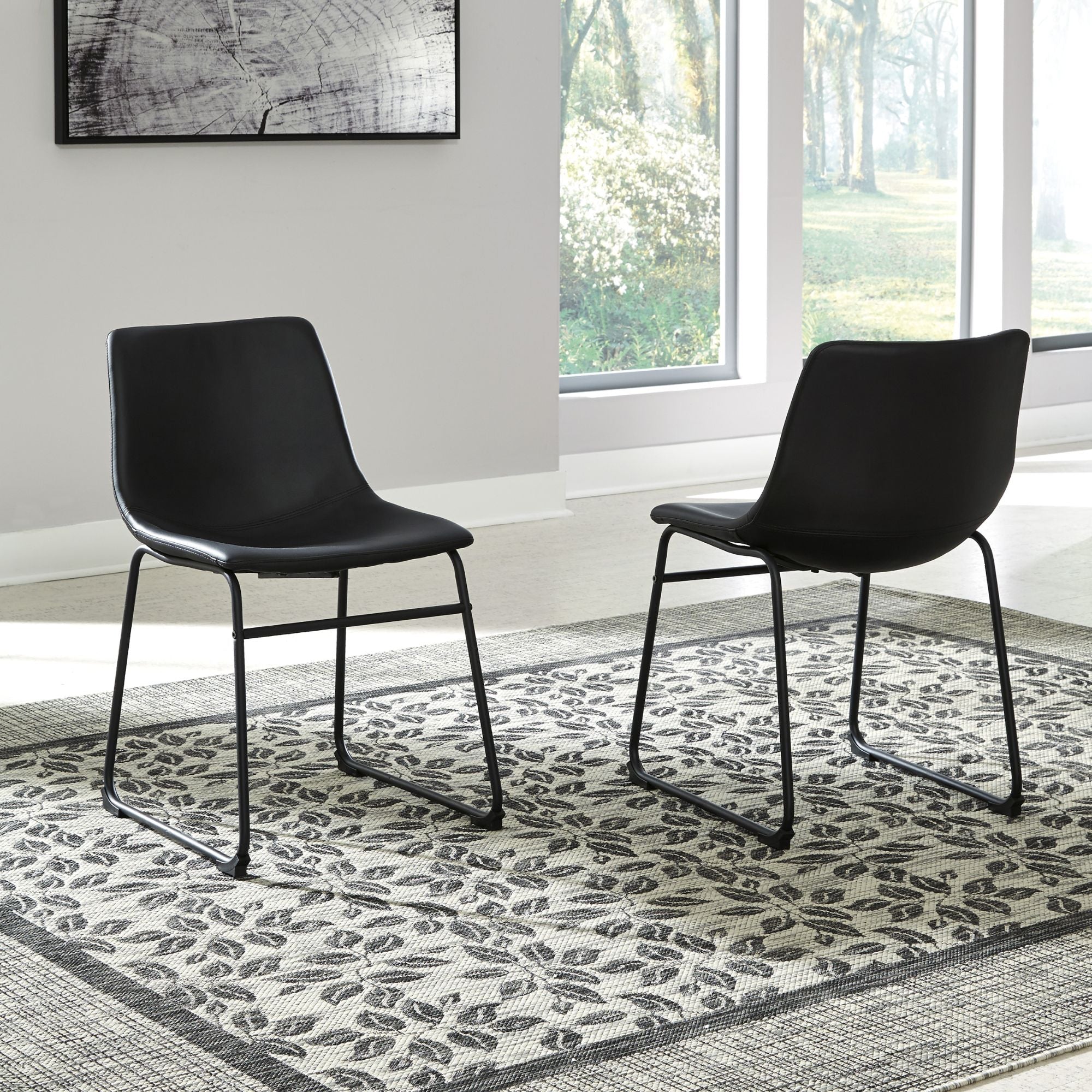 Set of two black Centiar UPH dining chairs by Signature Ashley with sleek, modern design and cushioned seats.