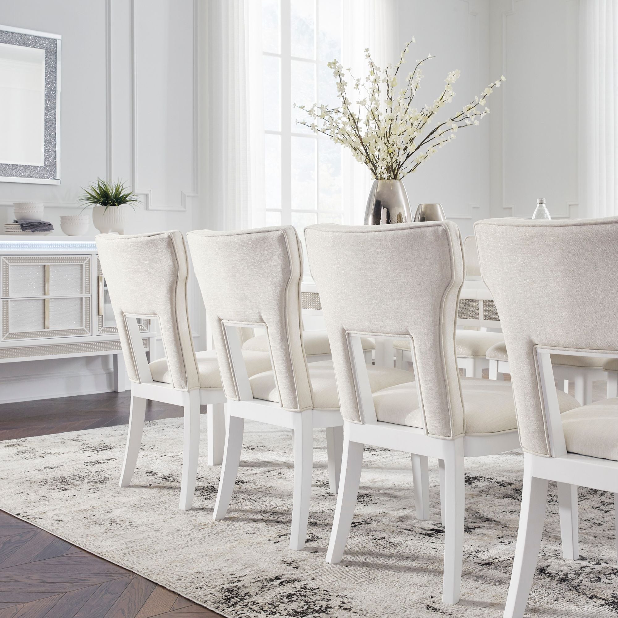 White Chalanna dining room set by Signature Ashley featuring a table and matching chairs in a modern design.