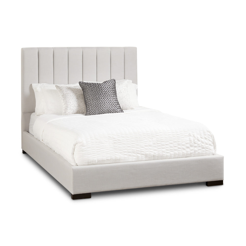 Xcella Channel Upholstery Bed with tufted headboard and sleek frame, shown from a three-quarter angle.