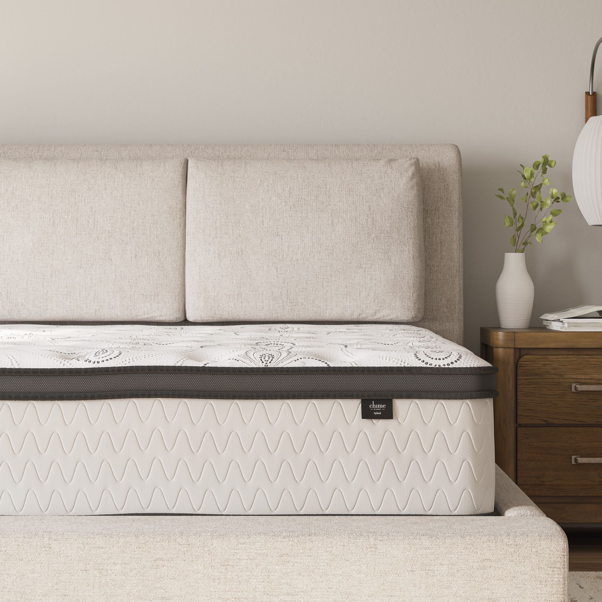 Signature Ashley Chime 12-inch ultra plush hybrid mattress with plush top, foam and coil support, shown in a cozy bedroom setting.
