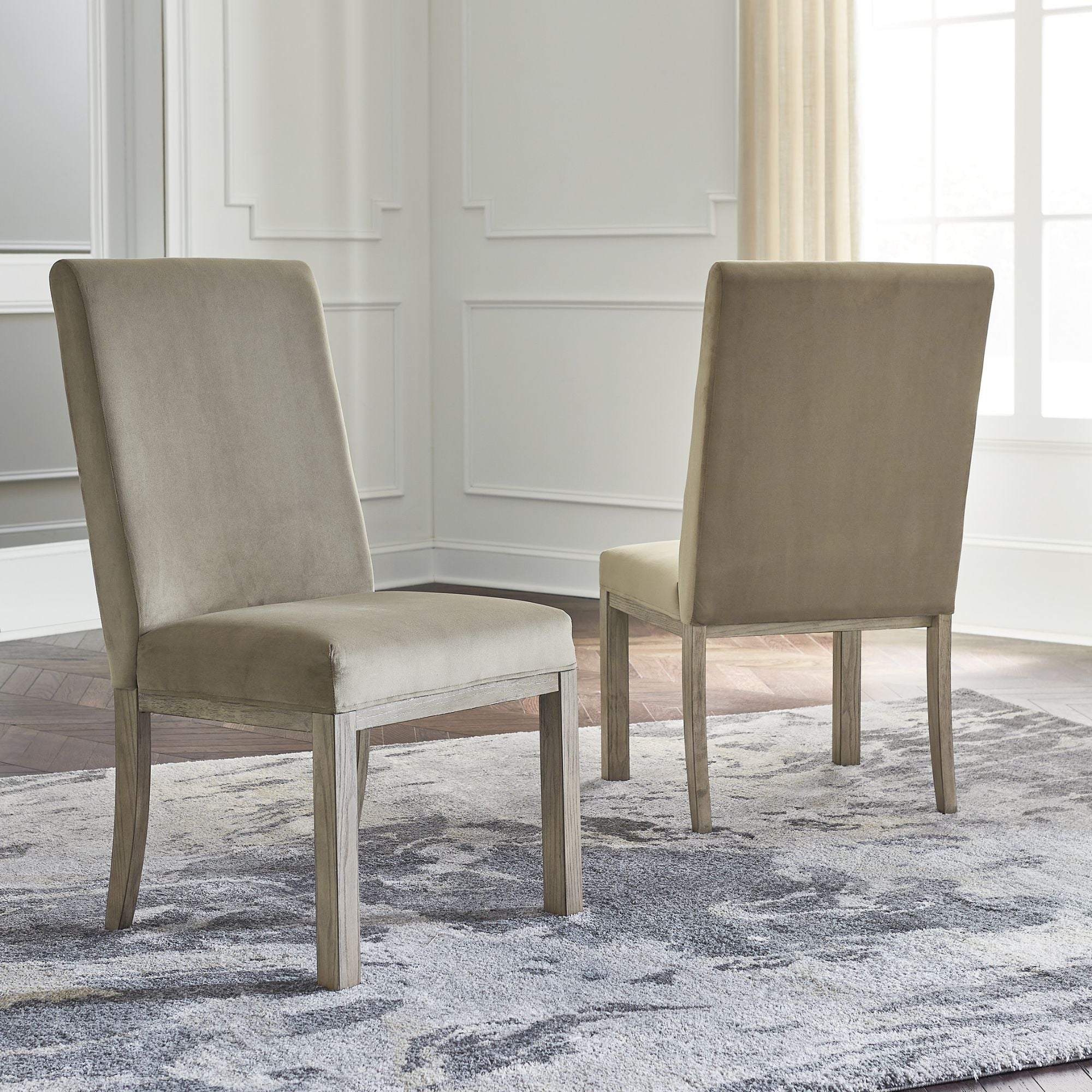 Set of two Chrestner UPH side dining chairs by Signature Ashley, featuring upholstered seats and wooden legs for kitchen or dining room.