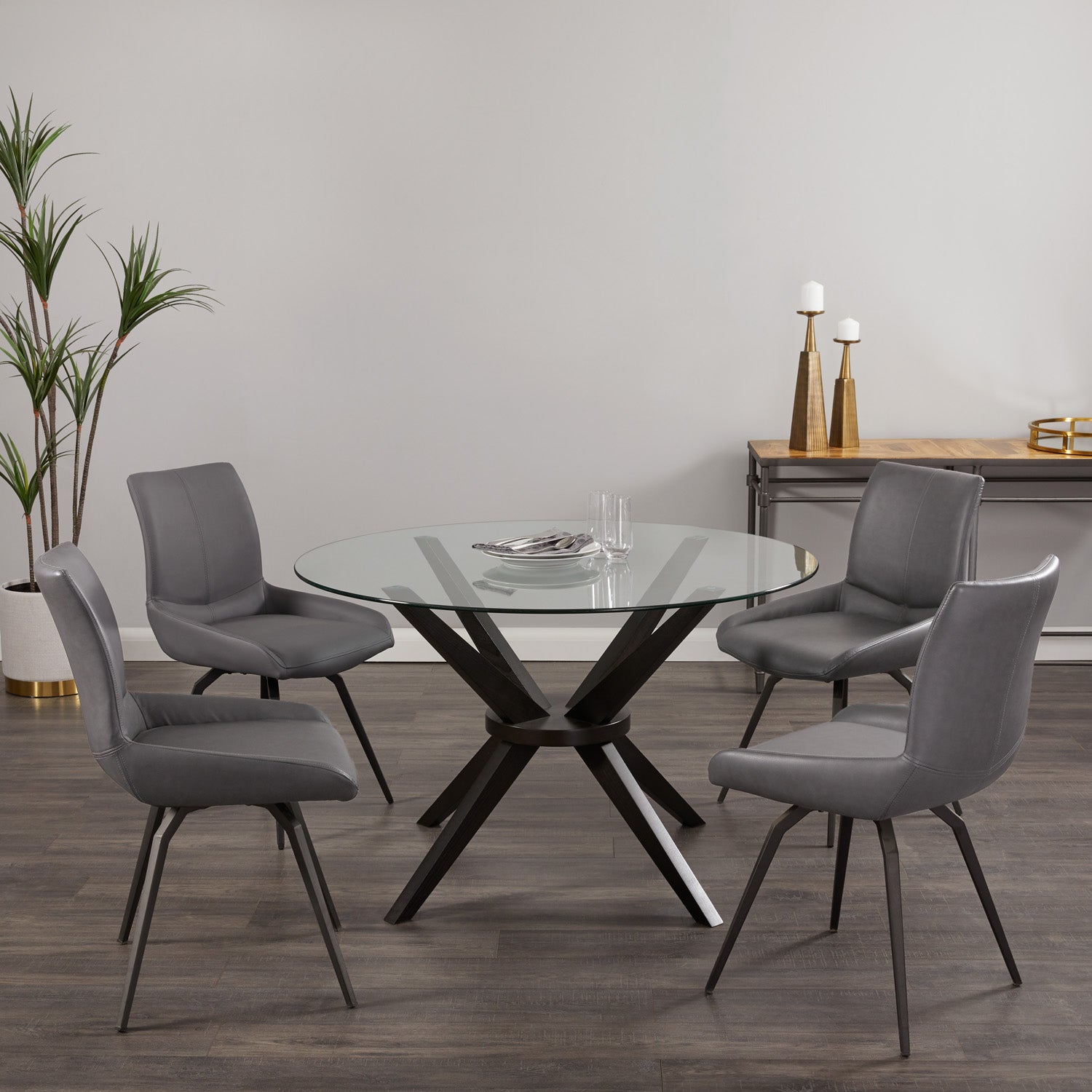 Pair of Xcella Nona swivel dining chairs in Norman grey faux leather with black legs, shown in a modern dining room setting