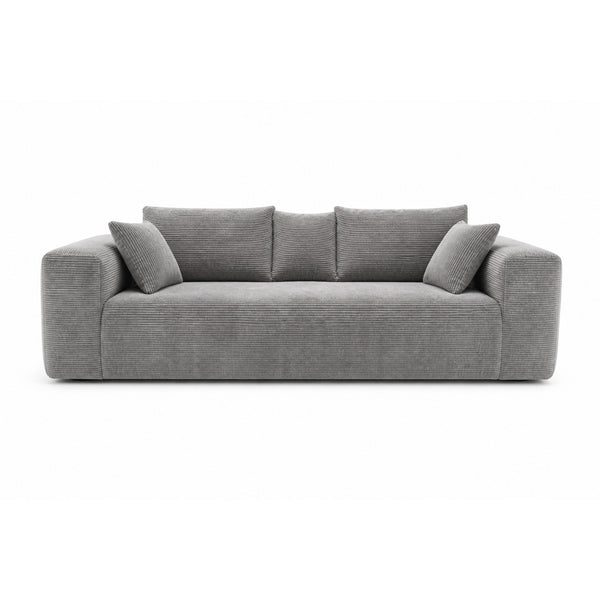 Grey low-profile compression sofa by Taste Living, showcasing modern design and plush upholstery for stylish comfort.