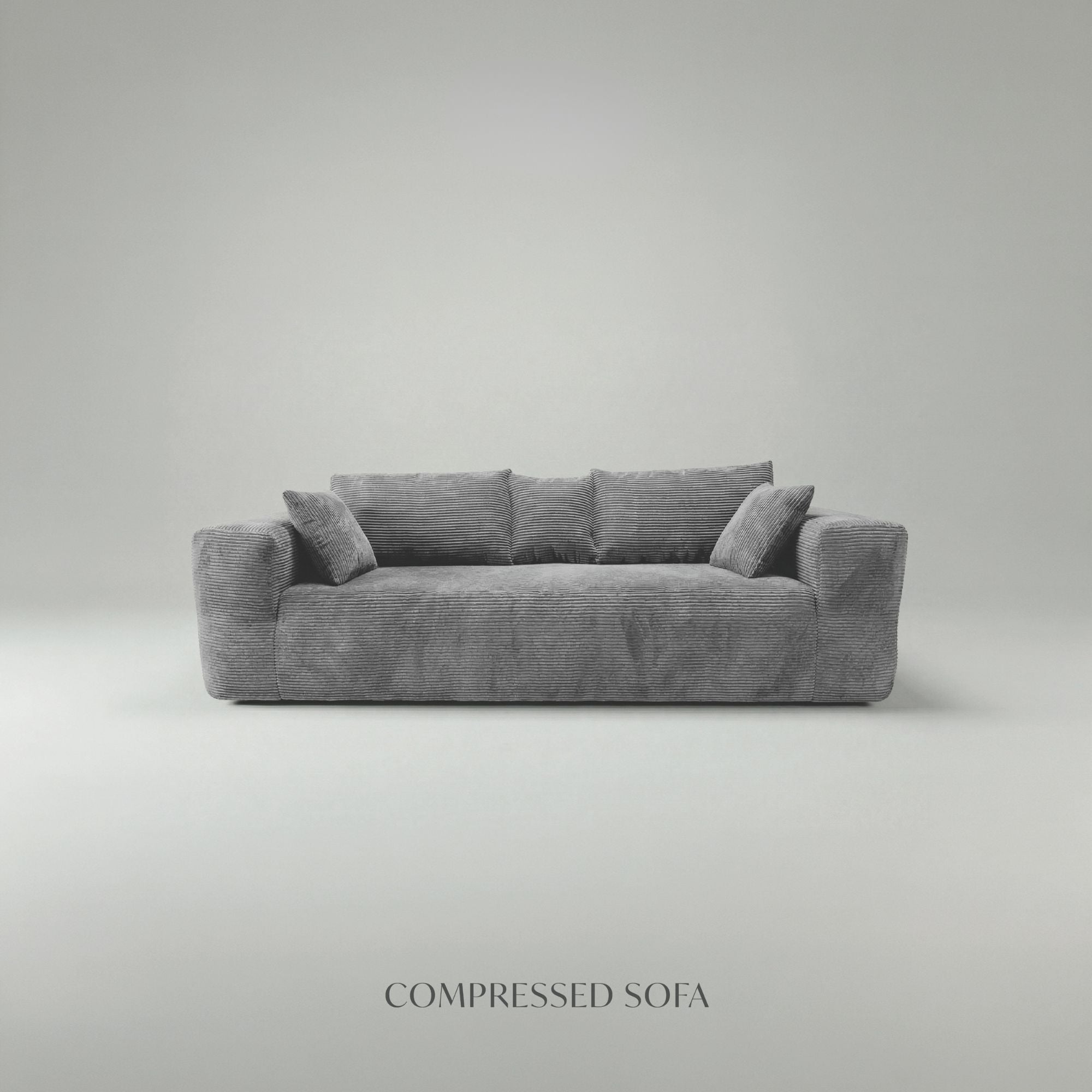 Grey low-profile compression sofa by Taste Living, showcasing a modern, compact sofa with sleek design and comfortable cushioning.