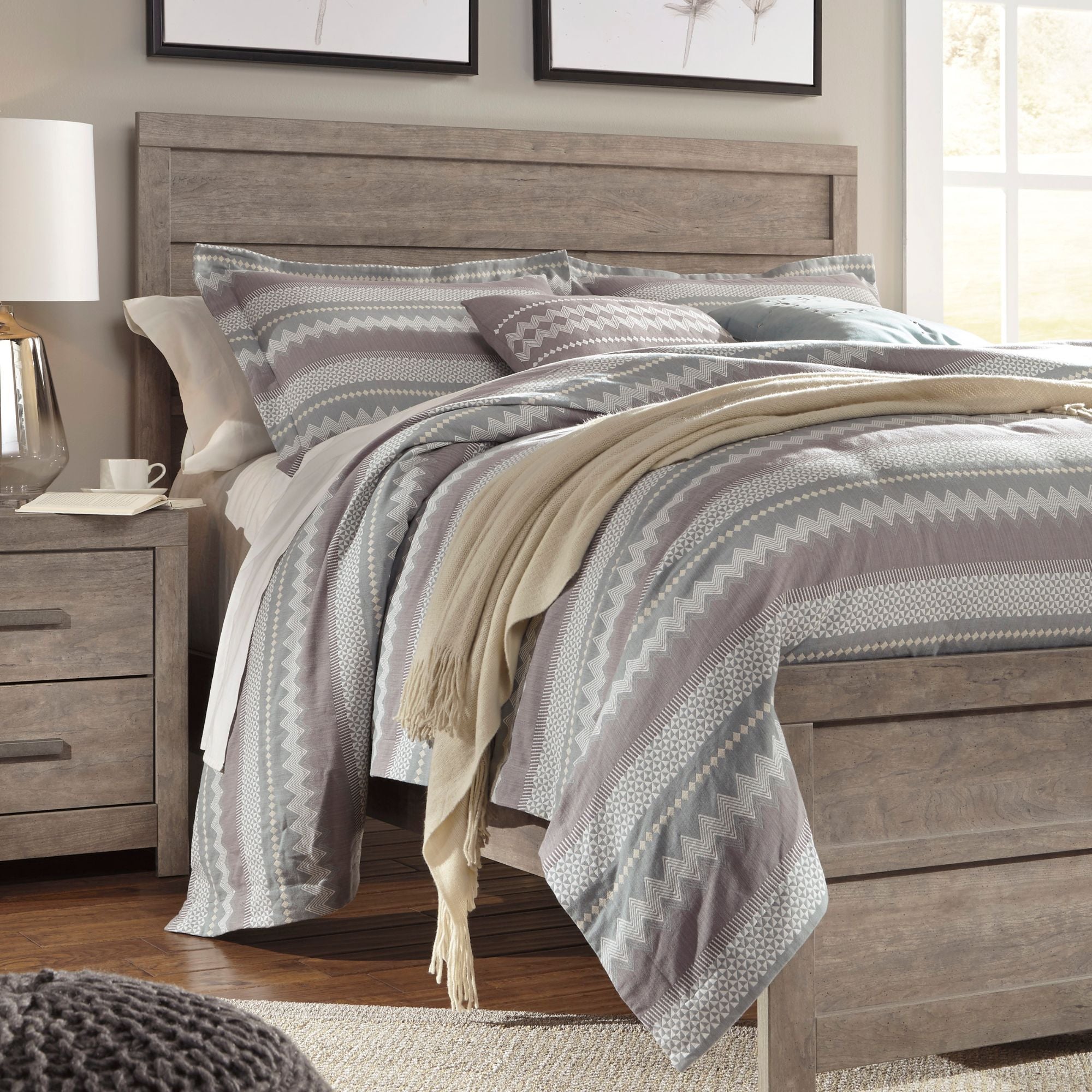 Grey Culverbach bed by Signature Ashley with a padded headboard and stylish bedding in a modern bedroom setting.