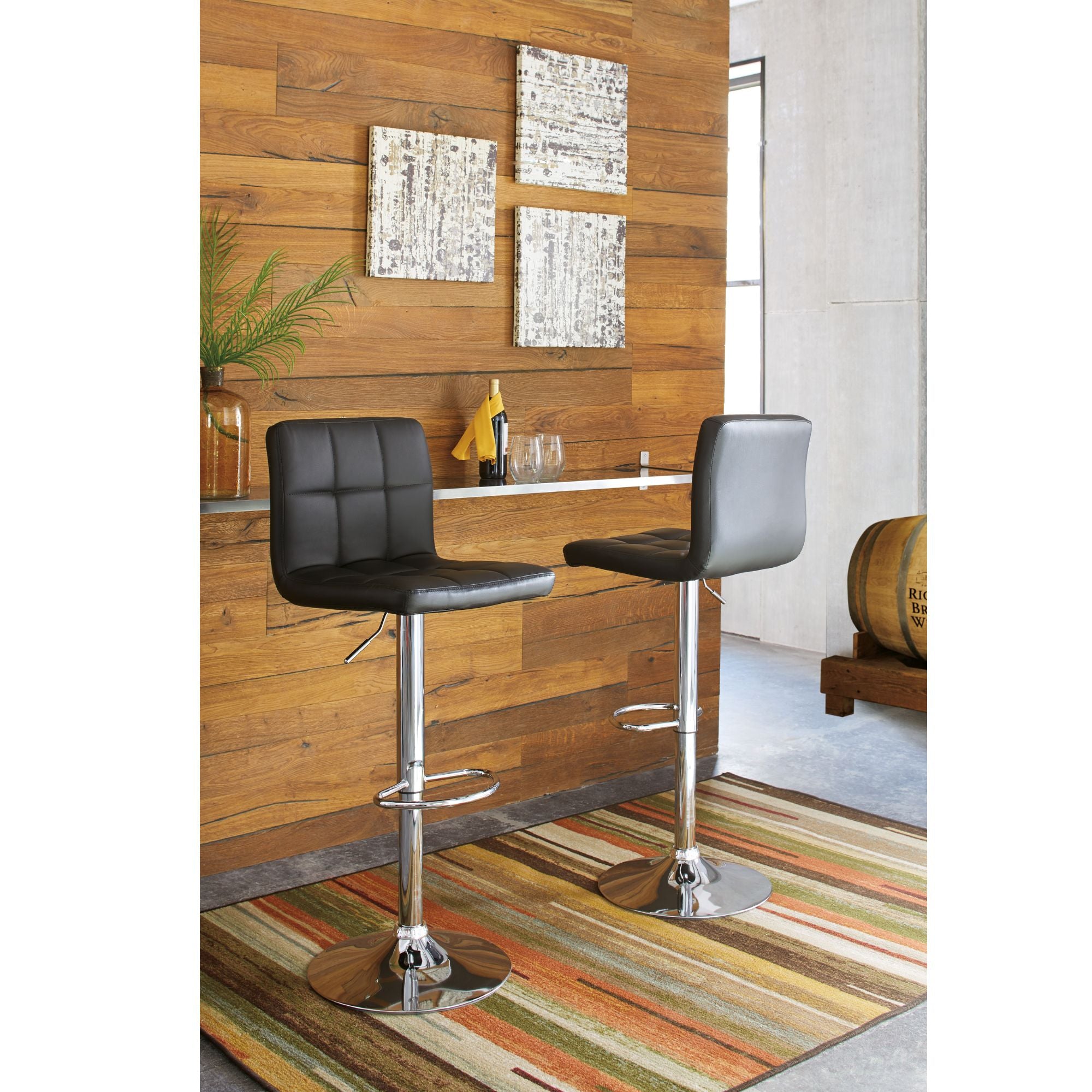 Black Bellatier Tall UPH Swivel Bar Stool by Signature Ashley with a modern design, featuring a padded seat and chrome base.