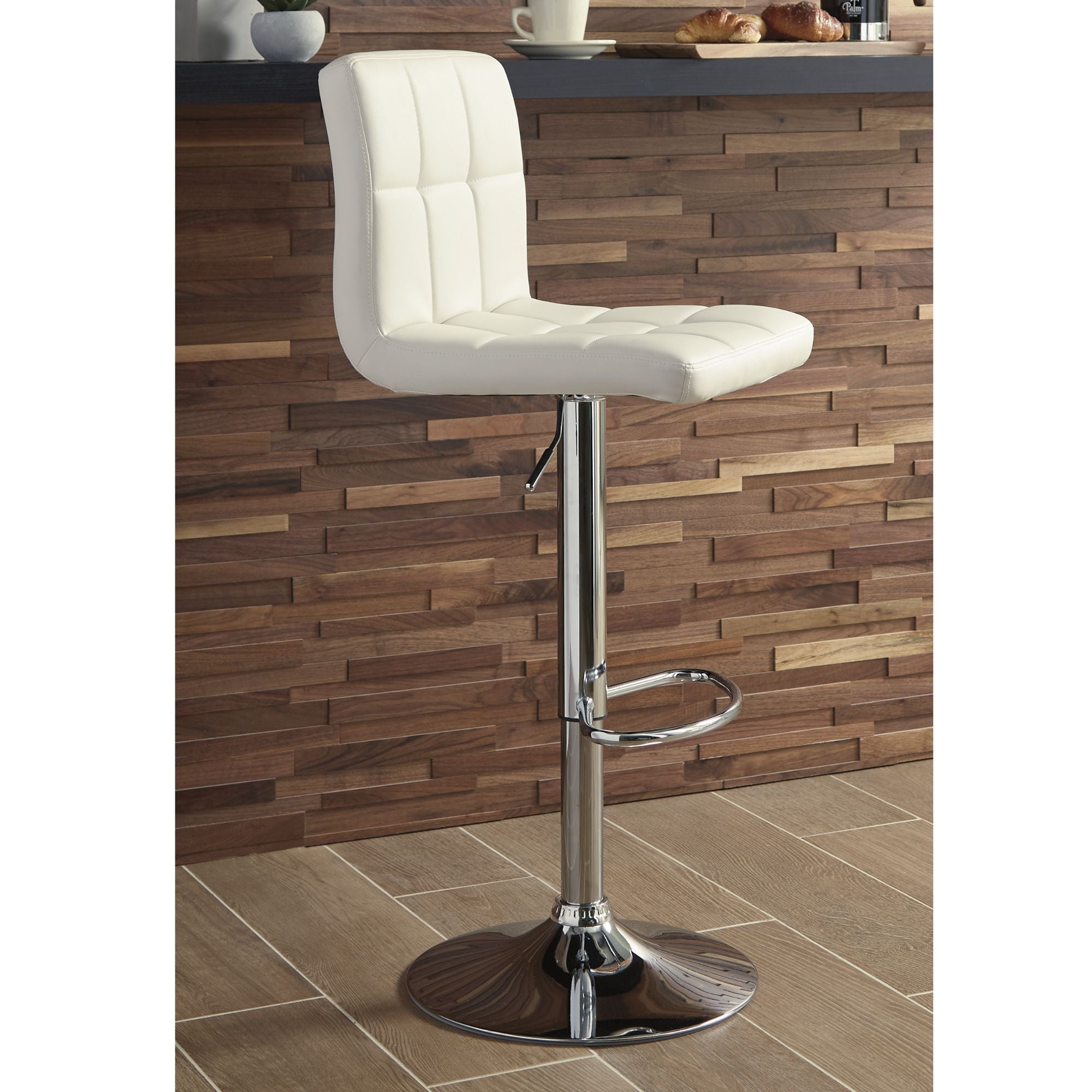 Cream Bellatier Tall UPH Swivel Bar Stool by Signature Ashley, showing a sleek, upholstered seat with a swivel base and modern design.